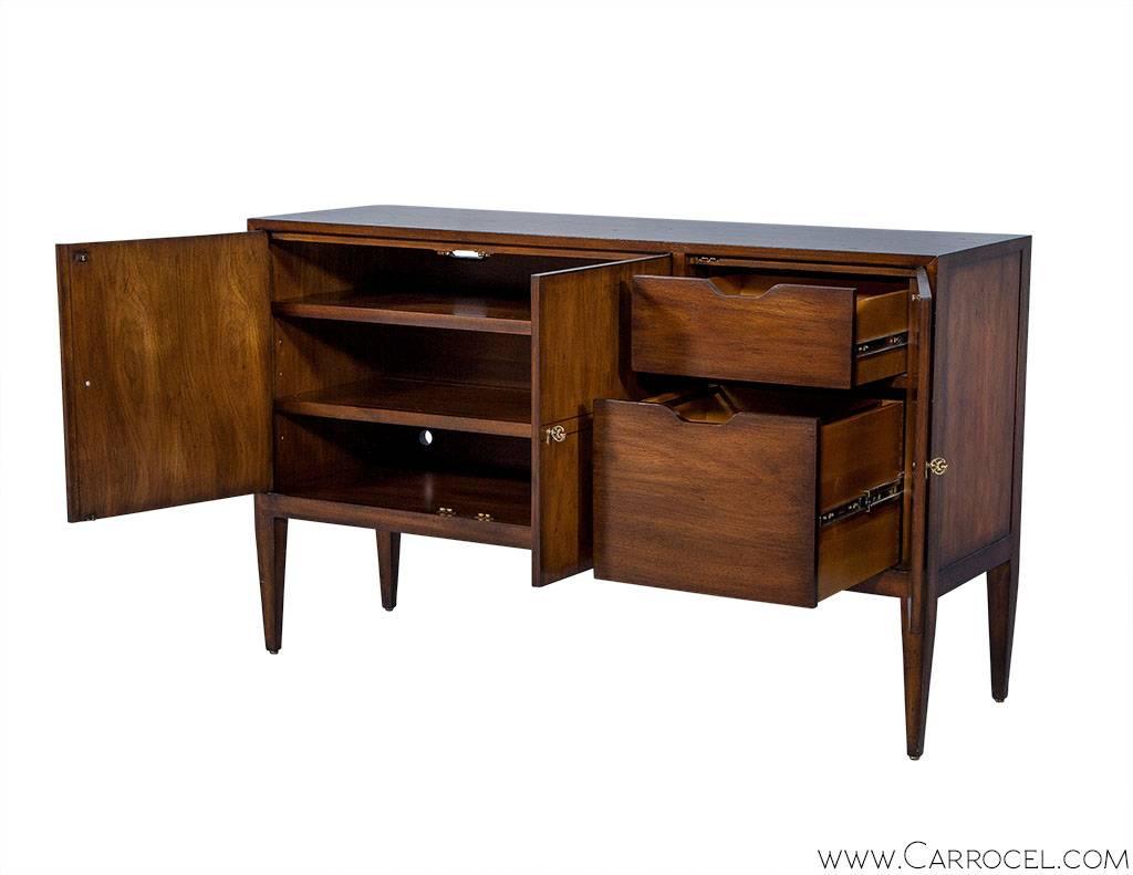 Distressed Walnut, credenza entertainment console. This newly made piece is finished in a rich hand rubbed and distressed rich walnut finish with classic high lighting to accentuate the flowing grain pattern. This cabinet features an adjustable file