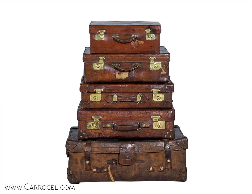 Part of the Carrocel Original collection, these cabin trunks have traveled the world in days long past. Manufactured in England during the early 1900s, these pieces are in original condition with natural wear and distressing contributing to the