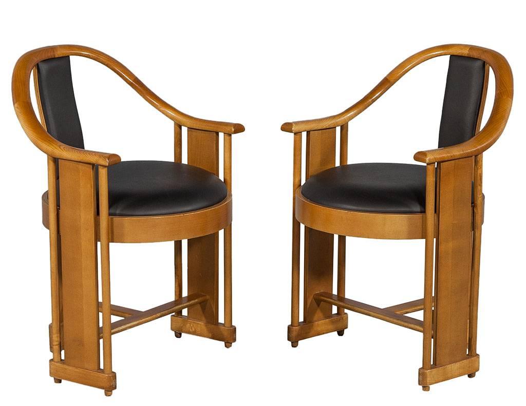 These original art deco, curved back arm chairs include a round vinyl seat and chair back. Mahogany finished in blonde stain for a beautiful contrast. 