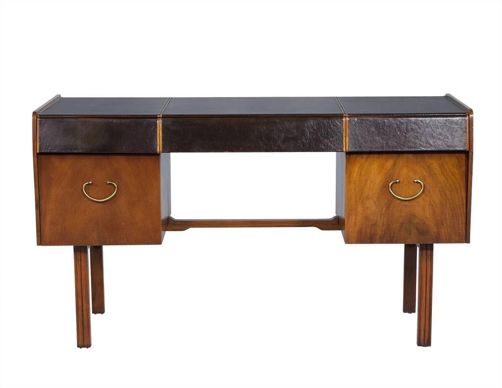 Handsome vintage piece with the character and charm of the Mid-Century Modern era. Designed with the desk top and top row of drawers wrapped in rich brown leather. The interiors of the drawers are outfitted with dividers for organization and the two