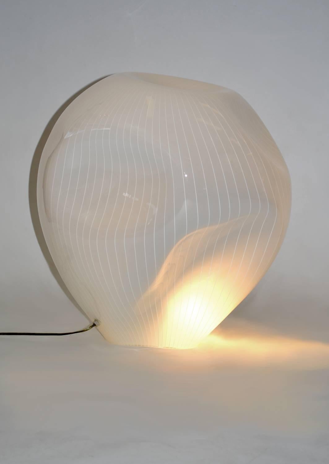 Sculptural, handblown glass table or floor lamp 1970's by Vistosi, Italy. Free-form, off-white cased Murano glass with bright white striations. Large enough to be used as a table lamp or a statement piece. Very good condition. In-line switch.
 