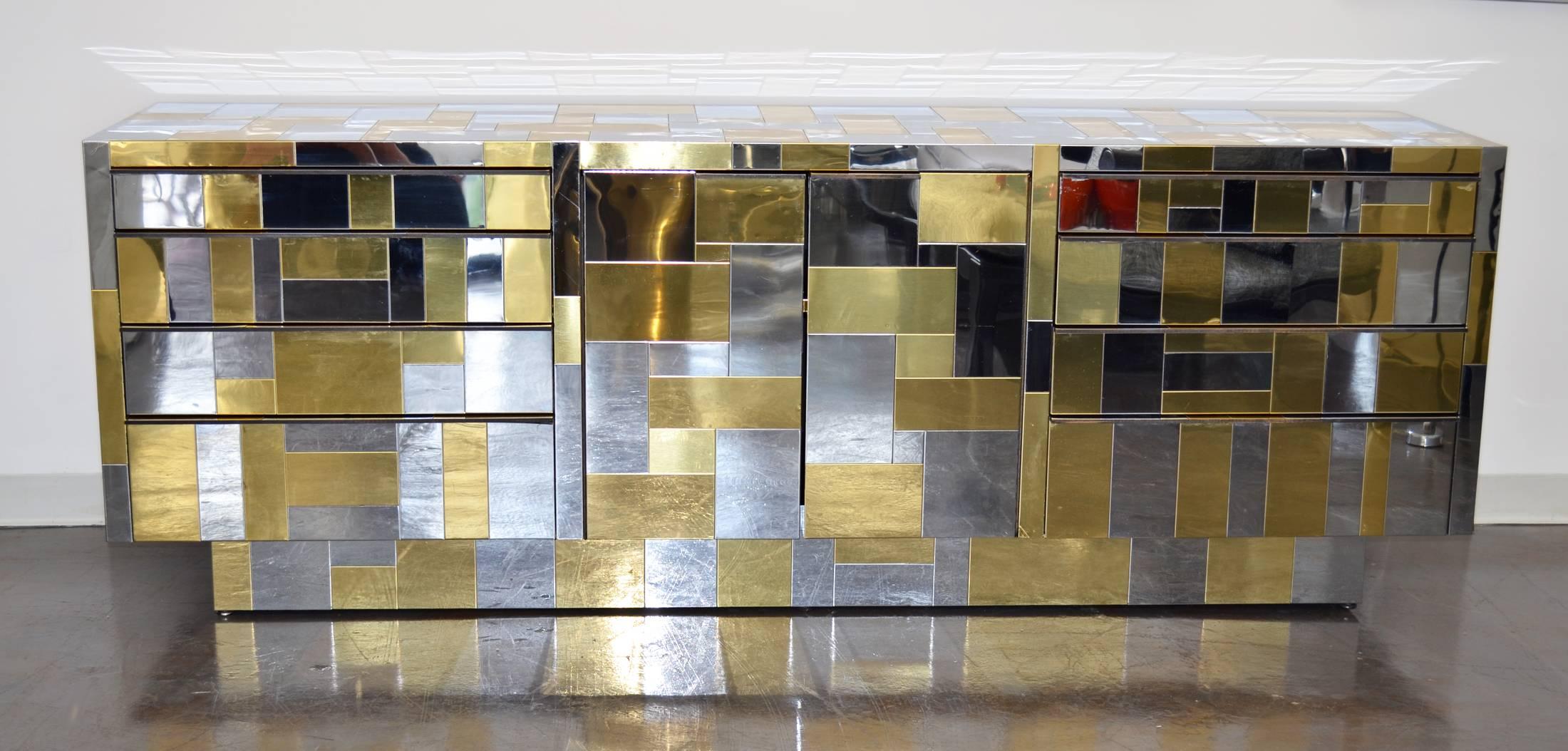Cityscape chrome and brass chest of drawers, cabinet or credenza designed by Paul Evans for Directional Furniture circa 1970's. Center barn doors conceal shelf, flanked on either side by eight varying-size drawers. A useful, surprisingly playful