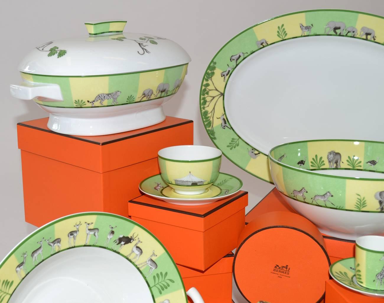 54 pieces of Hermès porcelain dinnerware china in the 'Africa green' pattern. Complete set for eight plus completer pieces (54 pieces total): 8 dinner plates, 8 salad plates, 8 soup bowls, 8 cups & saucers, 8 demitasse cups & saucers, teapot,
