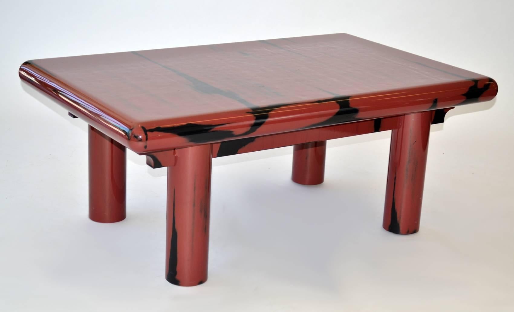 Cocktail Coffee Table Post Modern Lacquer after Karl Springer 1980's. Sturdy, handsome thickly lacquered coffee table with curved construction reminiscent of the Karl Springer Kytoto table. Currant red with black accents. A striking piece of