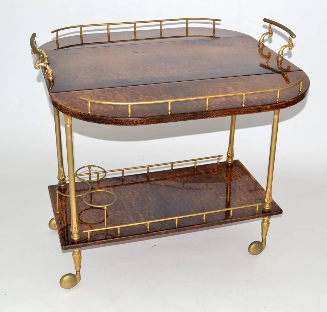 Aldo Tura goatskin drop-leaf bar or tea cart in chocolate brown parchment with brass hardware. Small wheeled version. Professional repair to bottom shelf