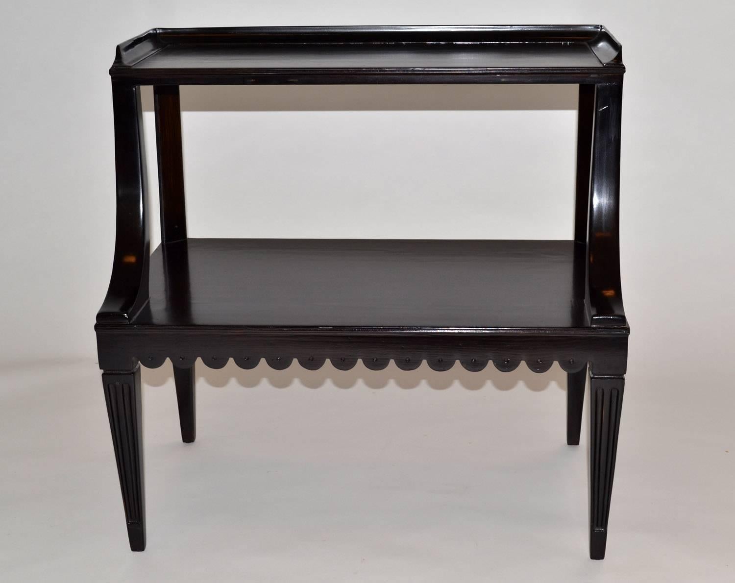 Pair of ebony side end occasional tables by Dunbar Wormley midcentury model 2275. Hard-to-find pair of ebonized mahogany two-tiered with columnar legs and a scalloped lower edge. Brass Dunbar tag and paper shipping tags intact. Professionally