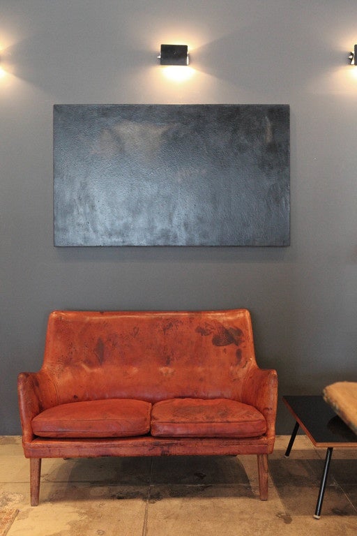 An original leather loveseat from Arne Vodder with rosewood frame, heavily patinated and extremely comfortable.