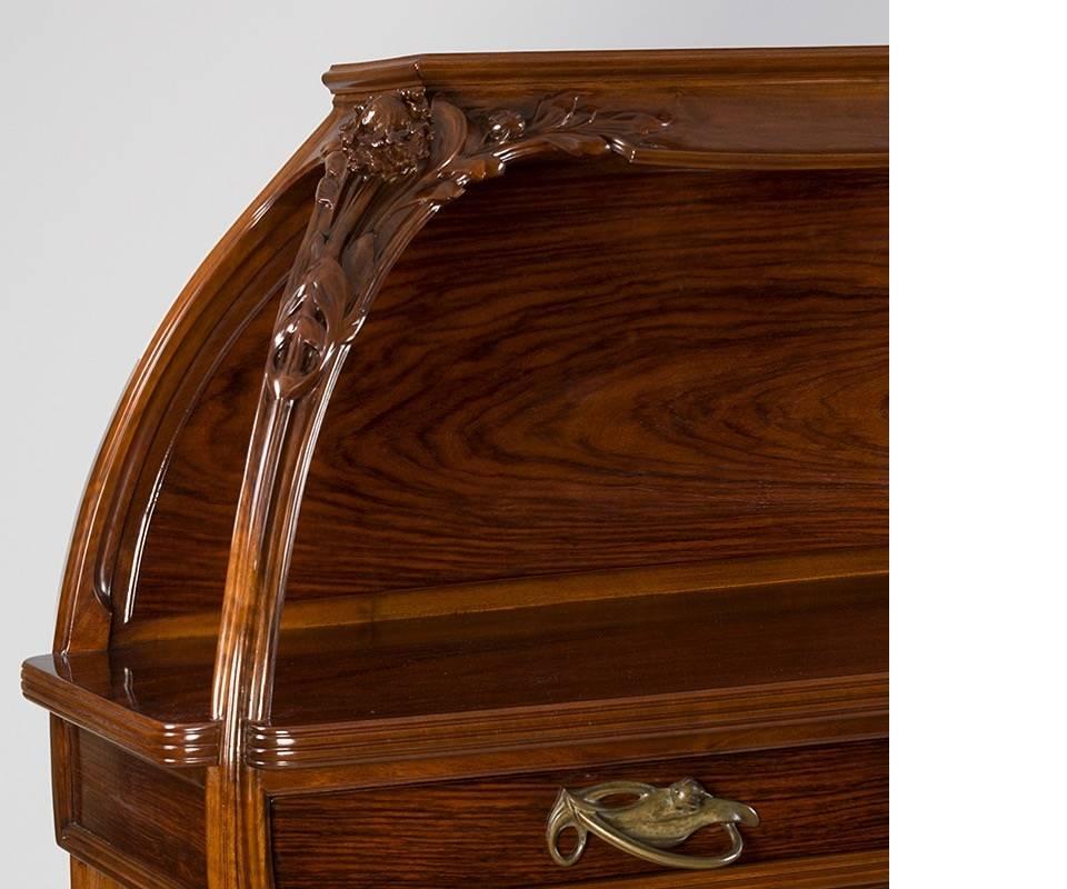 A French Art Nouveau French walnut server by Louis Majorelle in the “Cephataria” motif. The server has two drawers with gilt-bronze handles in a leaf motif, double door storage below and is elaborately carved throughout in a floral motif.

Similar