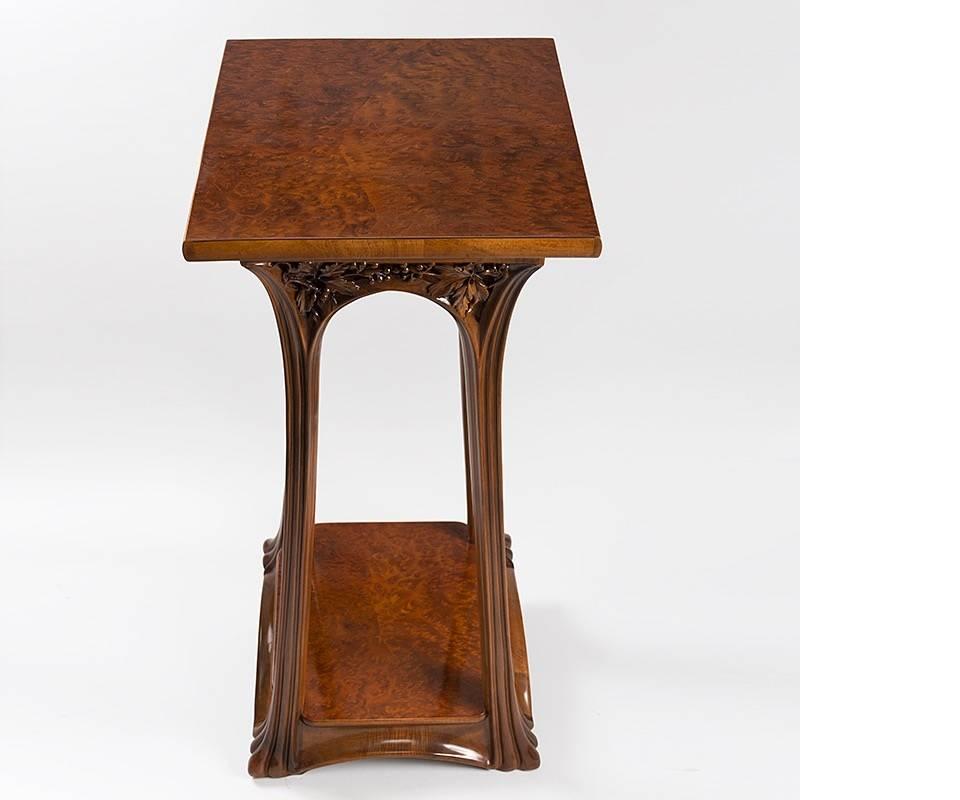 A French Art Nouveau pedestal by Louis Majorelle. The two tiers of this square pedestal are made of burl wood. The area below the top shelf is deeply carved with leaves and berries. The gently curving legs are also deeply carved, circa 1900s

A