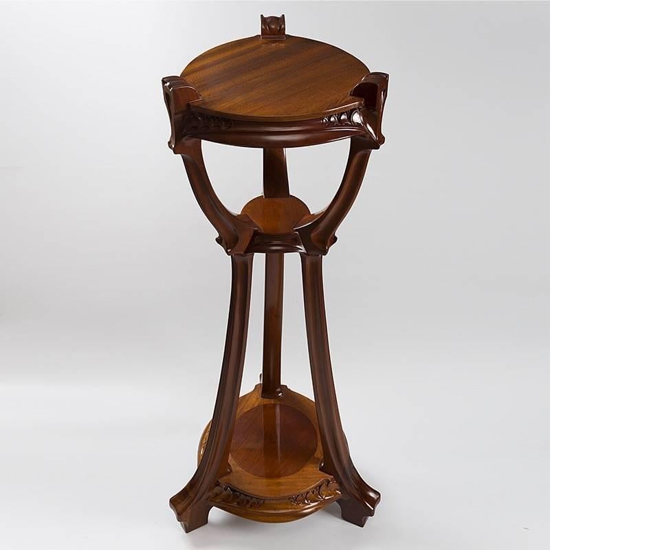A French three tier sellette in walnut with floral motifs by Jacques Gruber. This gracefully carved round sellette has three curving legs. Circa 1900. 

(MG #17804)
