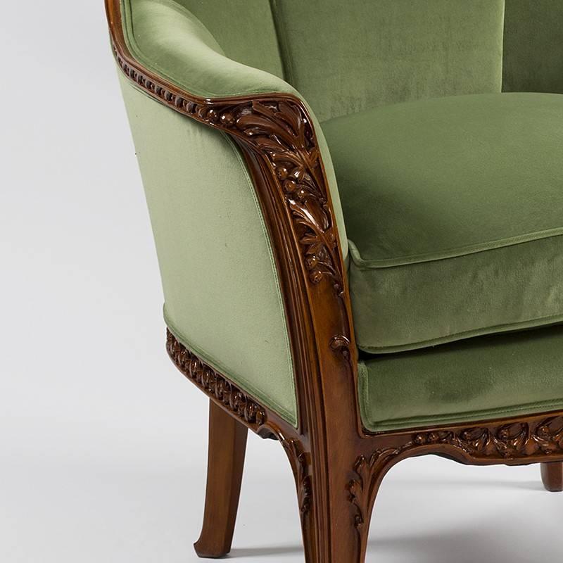 A pair of French Art Nouveau "aux Fougères" armchairs by Louis Majorelle. These chairs are decorated on their back edges,ams, legs and seat supports with carved fern fronds. They are upholstered in green, circa 1900. 

Similar chairs are