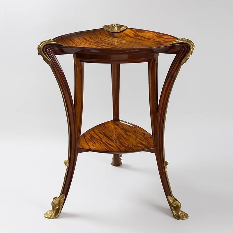 This two-tiered mahogany and tamarind wood table, adorned with gilt bronze water lilies—hence the French name, 