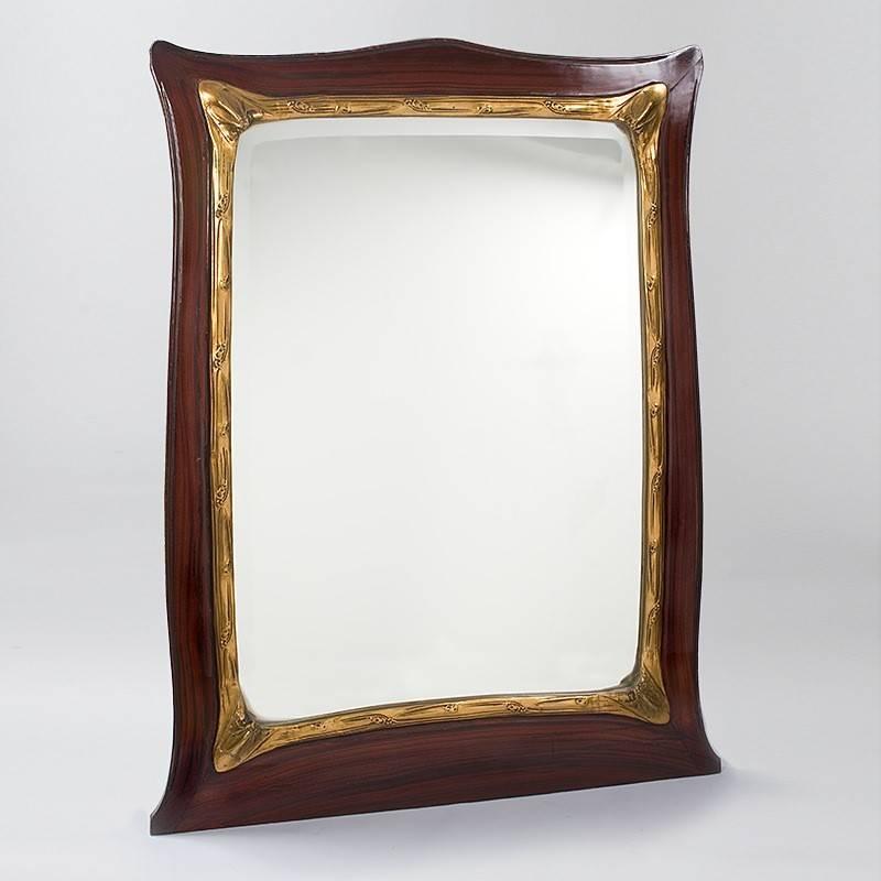 A French Art Nouveau glass and wooden mirror by Hector Guimard, featuring elaborate faux painting to resemble mahogany with gilt trim. circa 1900.

(MG #11392).
