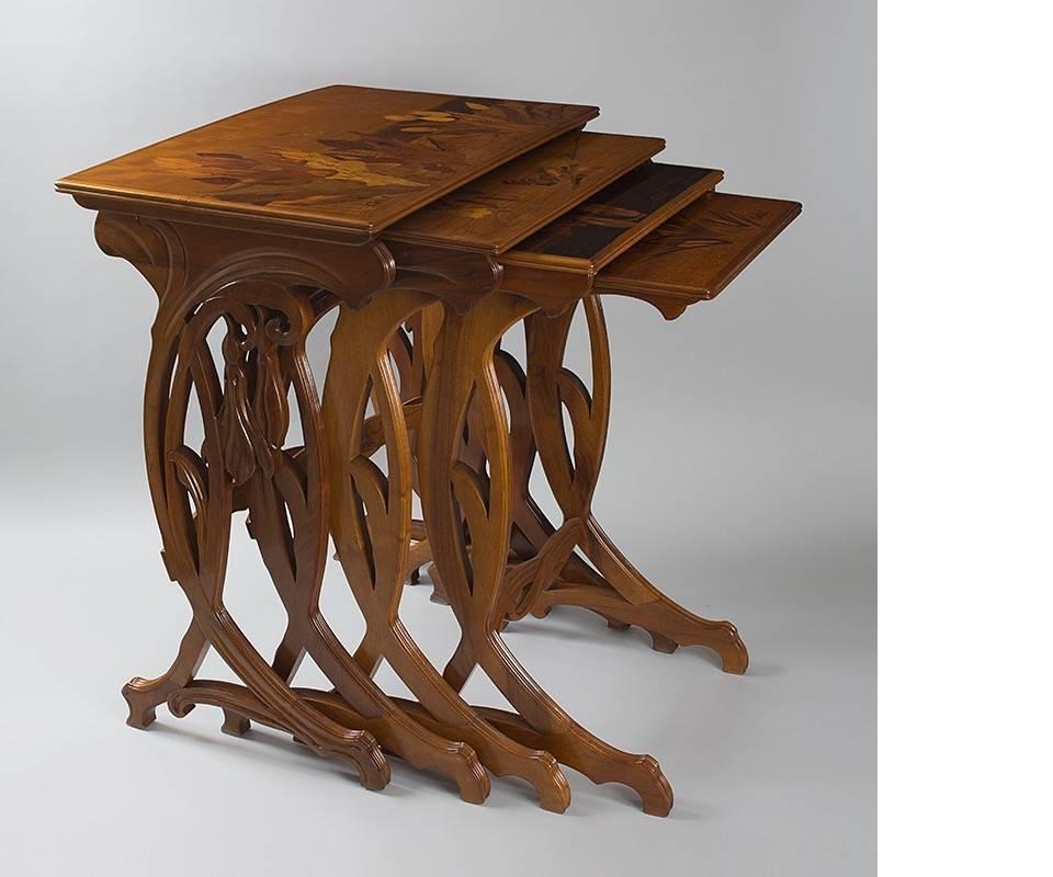 A set of four French Art Nouveau nesting tables by Emile Gallé. The tables have marquetry decoration depicting flowers and butterflies. Circa 1900. A similar set of tables is pictured in: Gallé Furniture, by Alastair Duncan and Georges de Bartha,