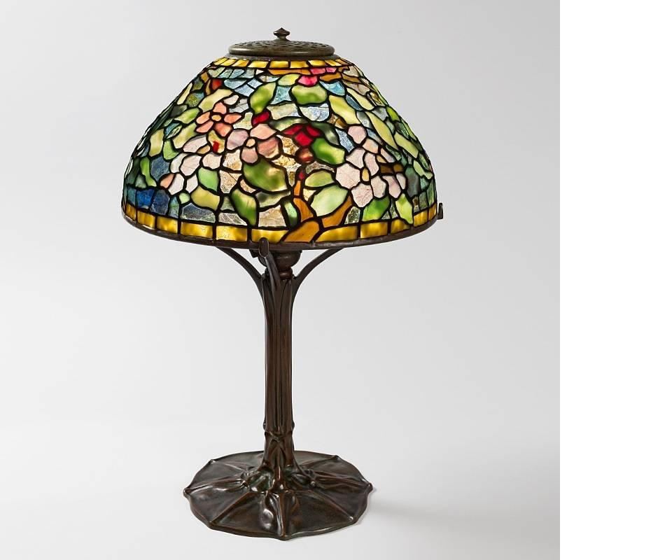 A Tiffany Studios New York "Apple Blossom" table lamp. 

A similar shade and base are pictured separately in: Tiffany Lamps and Metalware: An illustrated reference to over 2000 models, by Alastair Duncan, Woodbridge: Suffolk: Antique