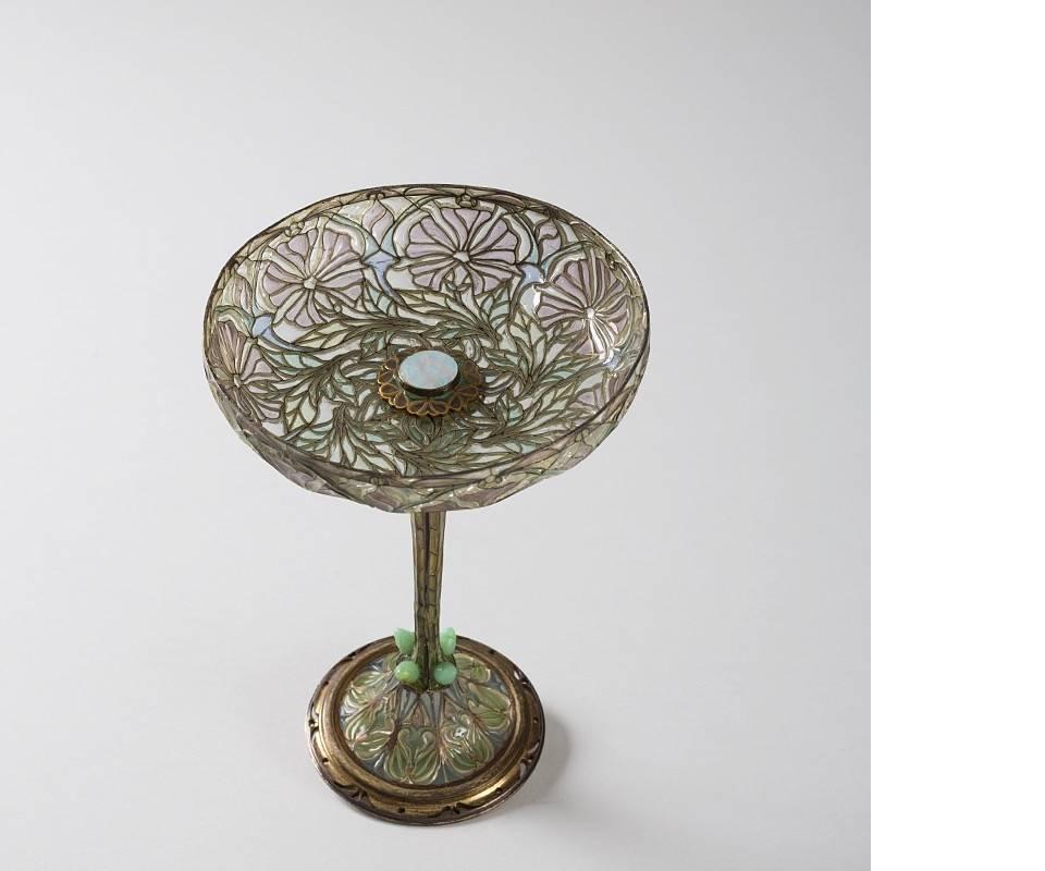 A French Art Nouveau silver and plique-a'-jour enamel coupe d’ornement by Euge'ne Feuilla^tre,
circa 1900.

This exceptional compote features delicate and stylized floral patterns on the upper and lower portions. Green leaves encircle the base of
