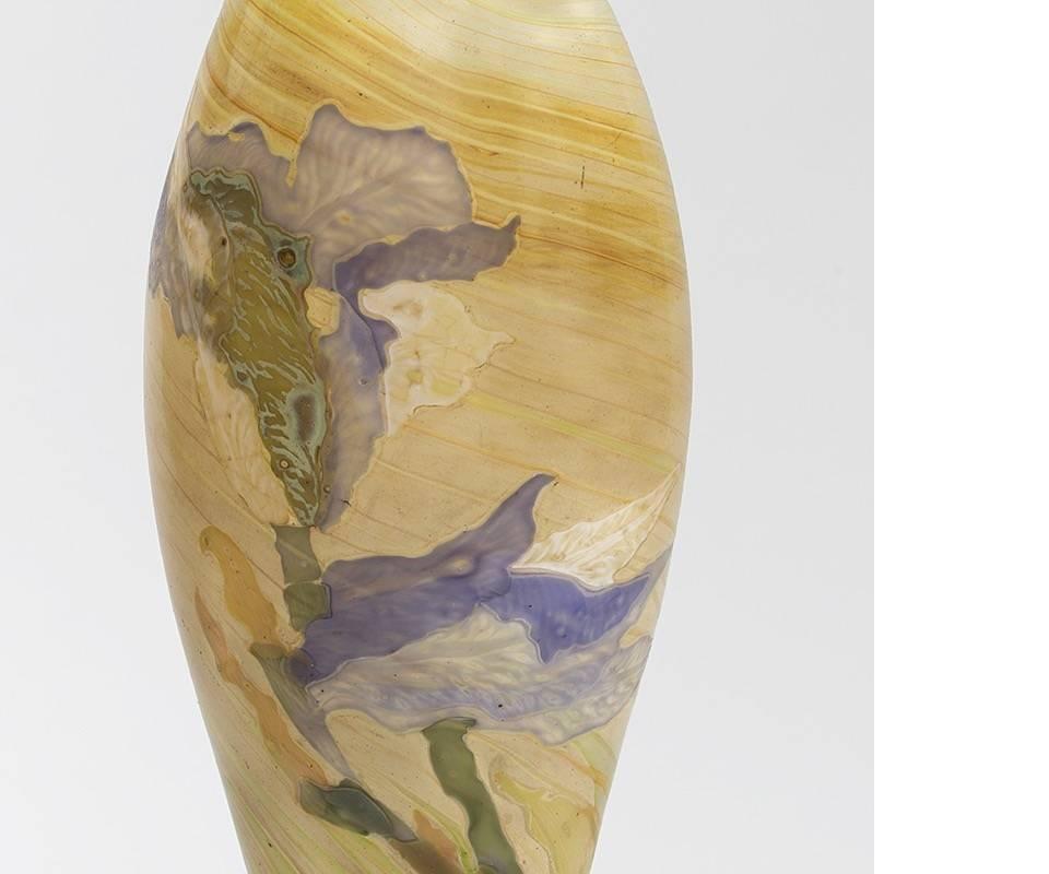 A French Art Nouveau “Flambé d’Eau” glass marquetry vase by Emile Gallé. This extremely rare vase features swirls of color that wrap around the entire piece. The lower portion of the vase is an opaque amber with twisting oranges and reds dancing