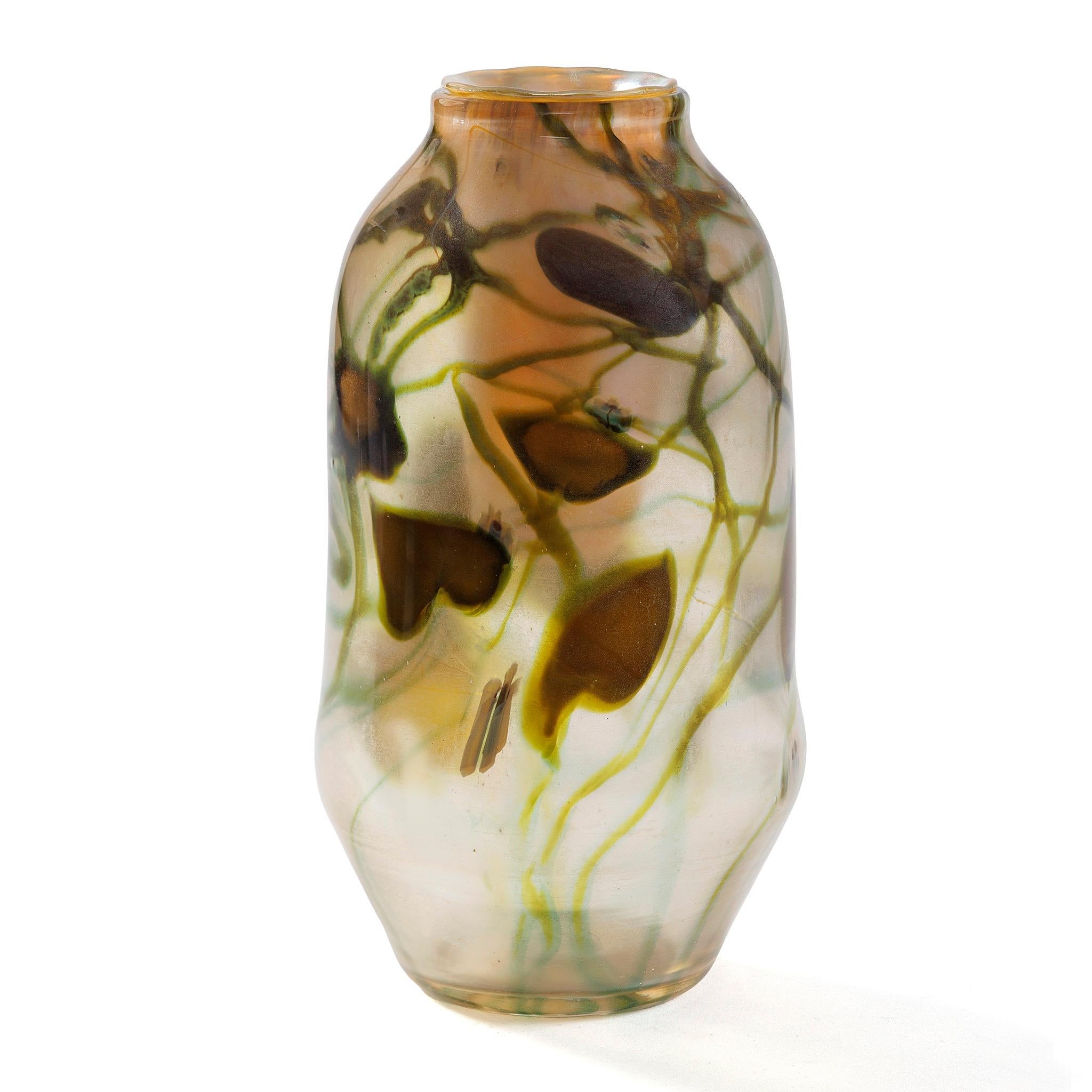 An extremely rare and collectible Tiffany Studios New York 'Leaf and Vine Paperweight' glass vase, this piece features a design inspired by the heart-shaped leaves of the honeyvine, rendered in reactive glass, and delicate white flowers formed from