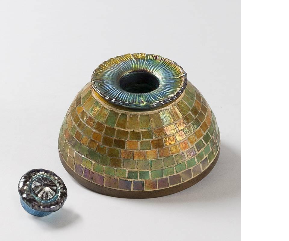 A mosaic favrile glass and bronze inkwell by Tiffany Studios New York.  Circa 1920.

A similar inkwell is  pictured in: Tiffany Lamps and Metalware: An illustrated reference to over 2000 models, by Alastair Duncan, Woodbridge: Suffolk: Antique