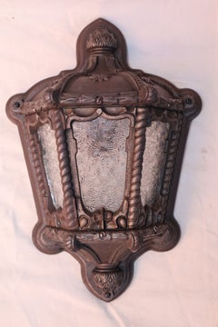 Rare pair of 1920's cast iron outdoor sconces
