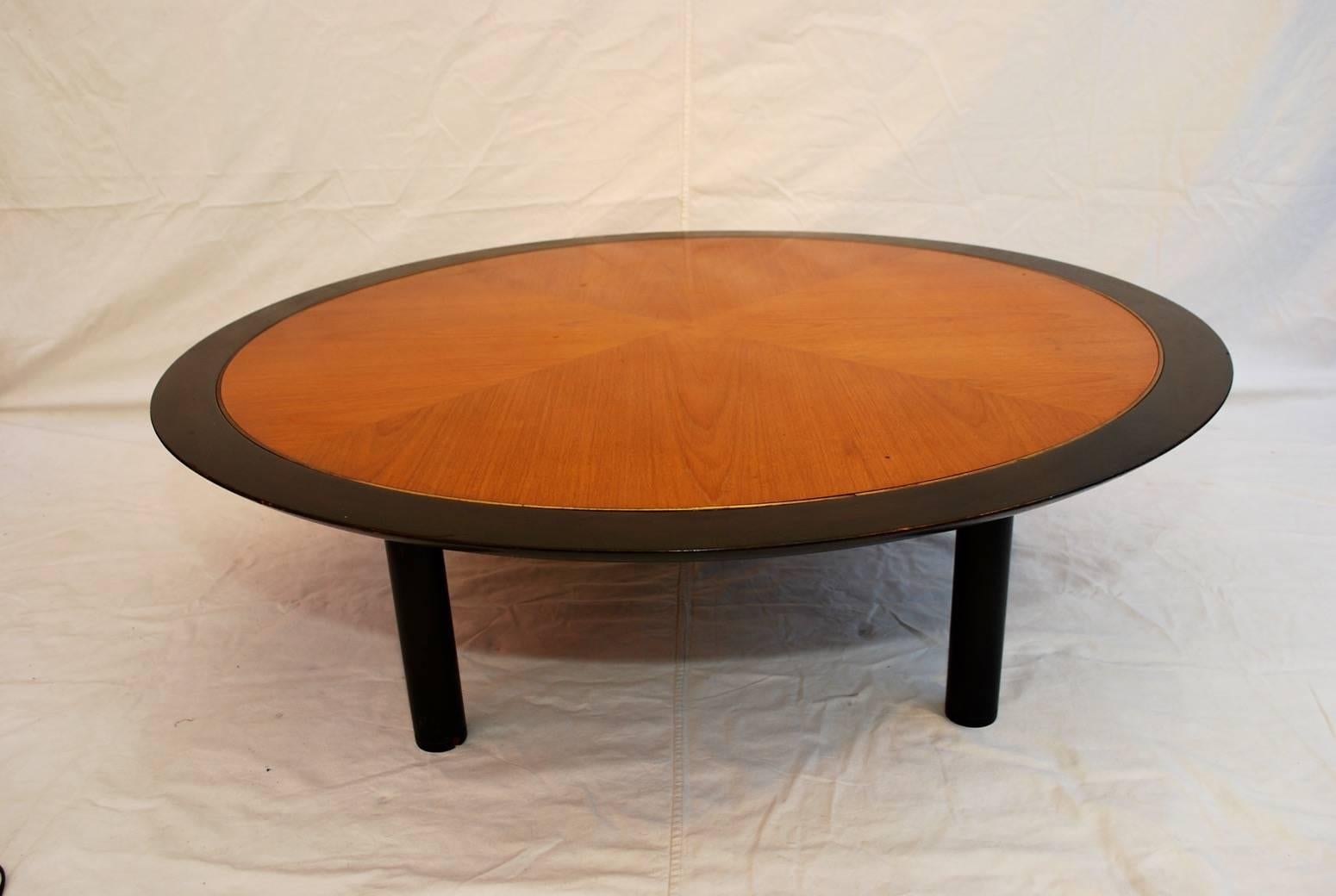 A beautiful coffee table by Baker, it has the ebonized wood with an inlaid brass and a beautiful walnut wood inlaid.