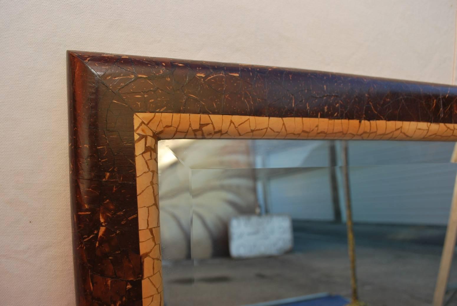 A rare mirror made of wood with coconut shell, the patina is so much more beautiful in person, it can be hang either vertically or horizontally.