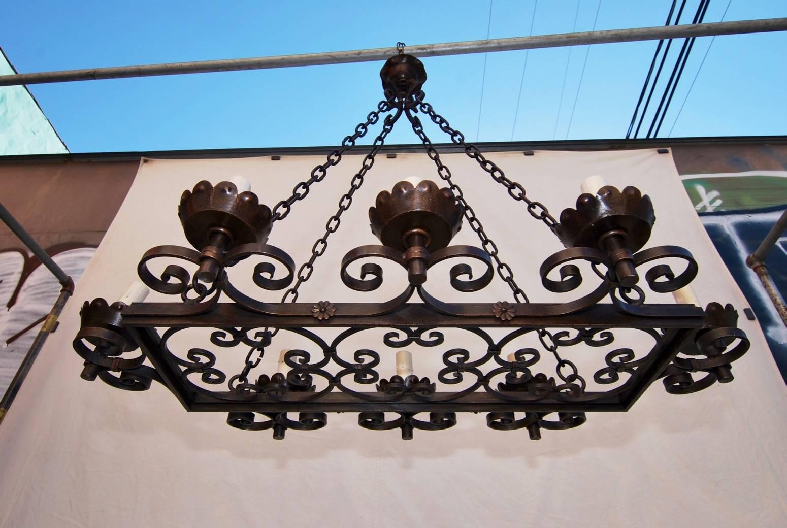 A beautiful all handsmade wrought iron chandelier, the patina is a lot nicer in person, the height can be shorter. 

We have over three thousand antique sconces and over one thousand antique lights. If you need a specific pair of sconces or