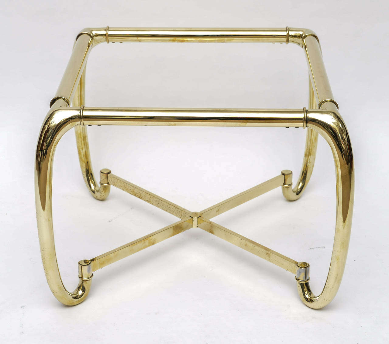 Brass side table attributed to Mastercraft in the Mid-Century Modern Period.
Heavy table with his unique shapes and made in Italy.
Comes with a glass top.
 