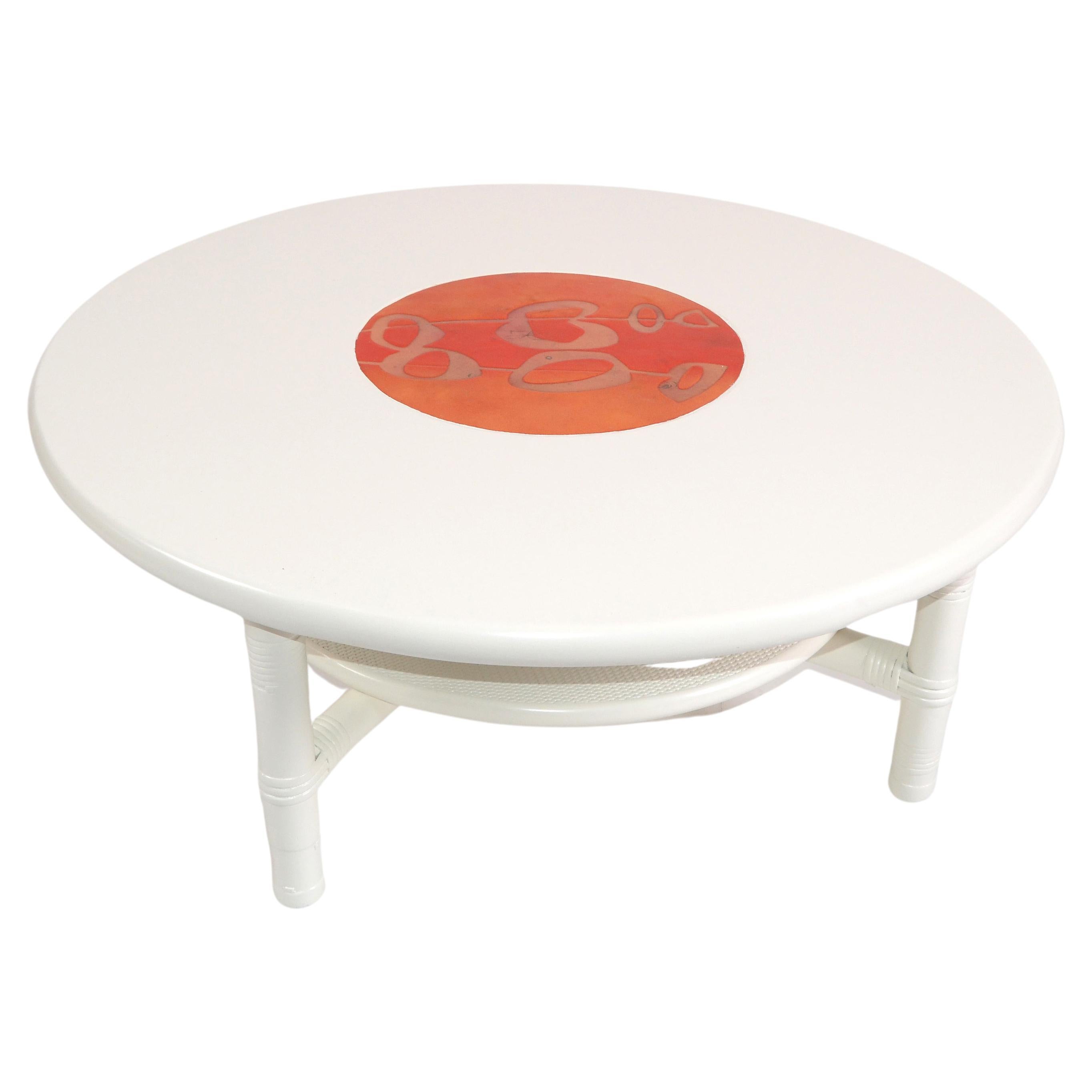 Mid-Century Modern round white two-tier bamboo, rattan and enamel coffee table from the late 1970.
The center of the top is a beautifully designed red and orange enamel inlay.
This coffee table has been restored and is ready for your home.
  