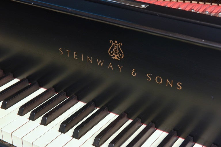 Steinway grand piano from 1921, completely rebuilt to original specifications and re-finished by Steinway, New York in a mat black finish.
Complete with a concert bench with black tufted leather seat matching the piano. Model S.