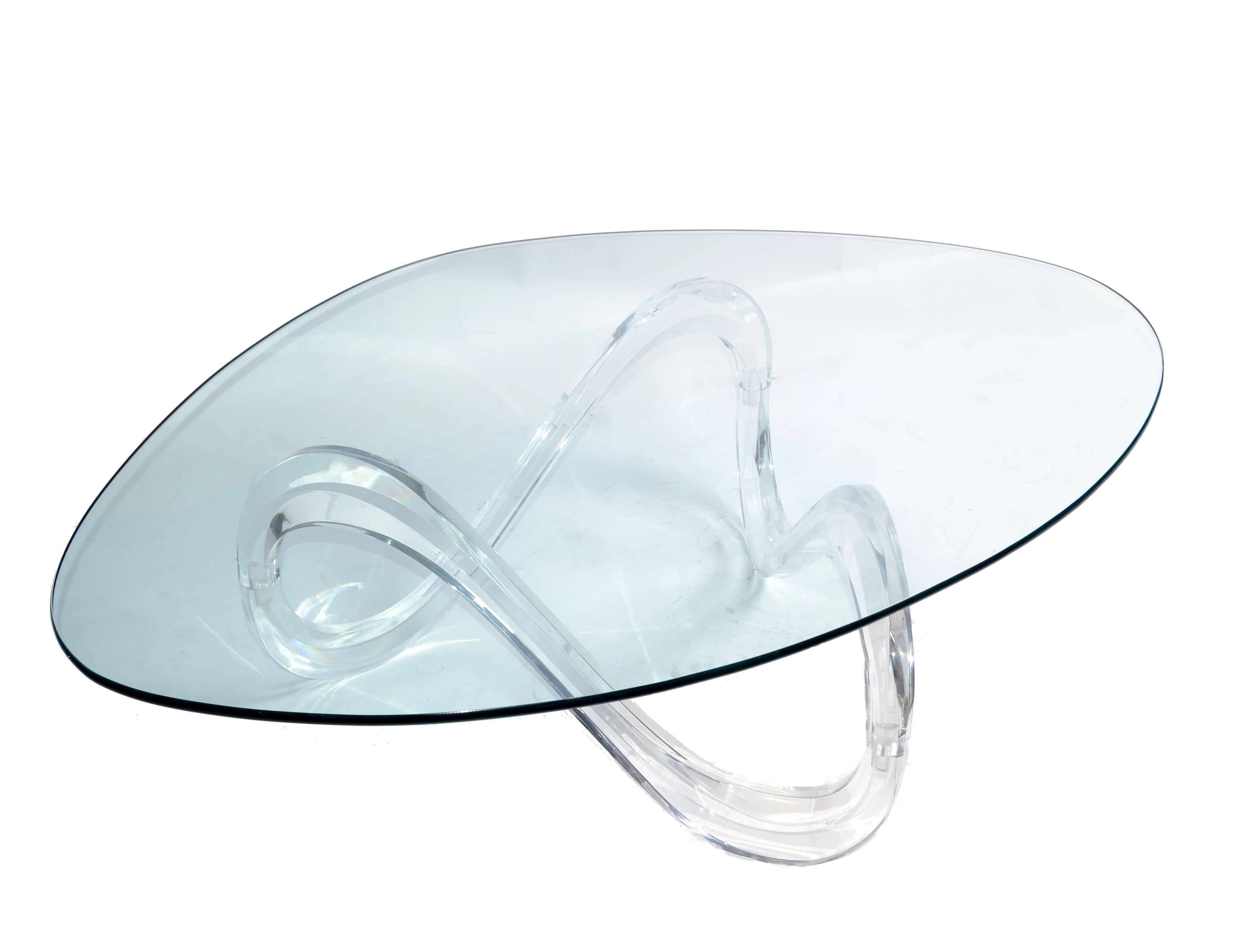 Mid-Century Modern Lucite ribbon coffee table in the manner of Charles Hollis Jones with green tinted kidney shaped glass top.
No markings.
A stunning sculptural coffee table with a triangle fluid base.