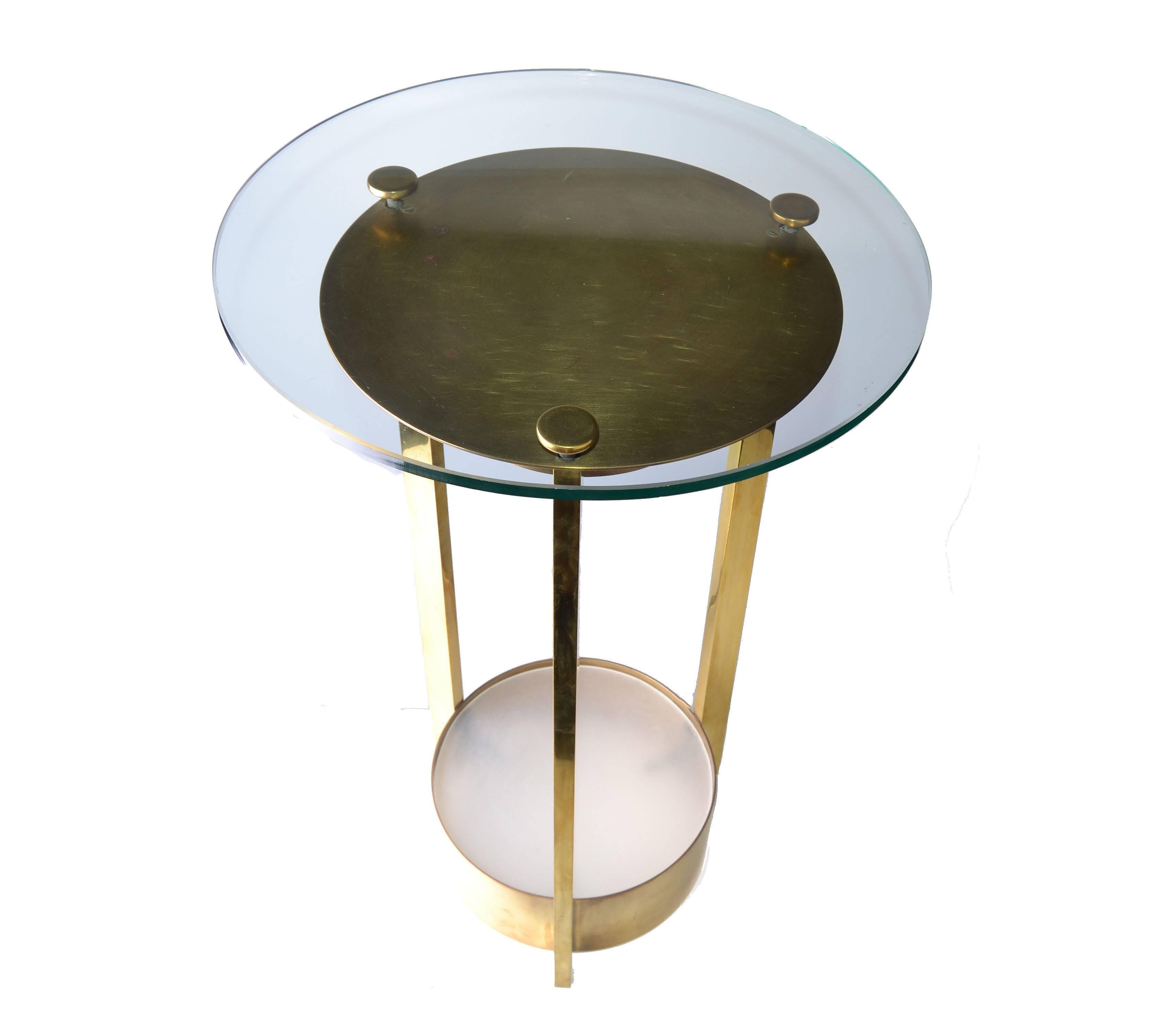 Dorothy Thorpe illuminated brass and glass side table. Solid brushed brass round glass side table with light at the top. Bottom stand is frosted glass. Socket is ceramic. 40 wattage of light bulb.