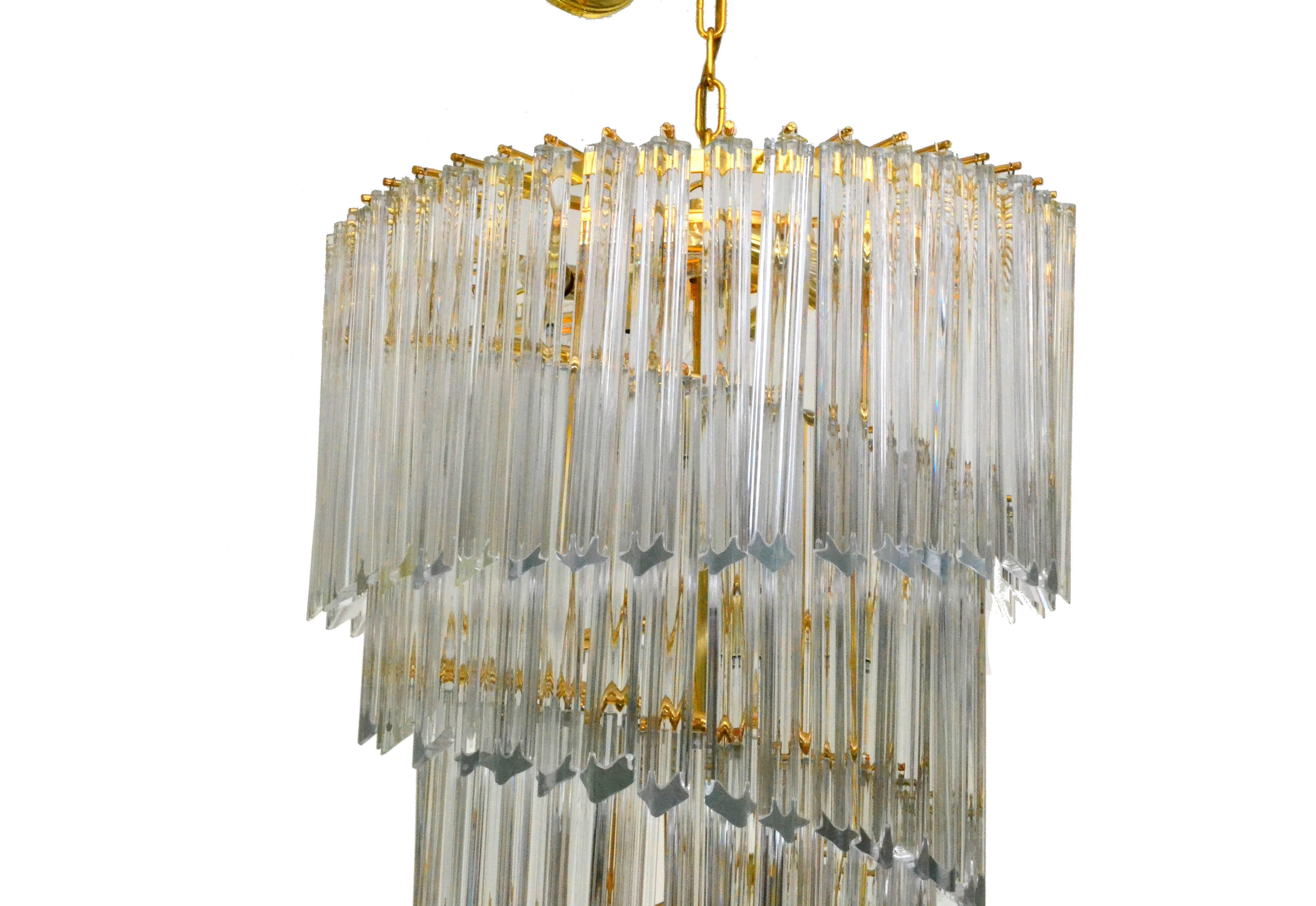 Seven-tier Venini quatro punta prism chandelier. Heavy leaded Murano crystal prisms haning on a brass frame.
Twelve lights make this fine Venini chandelier stand out.