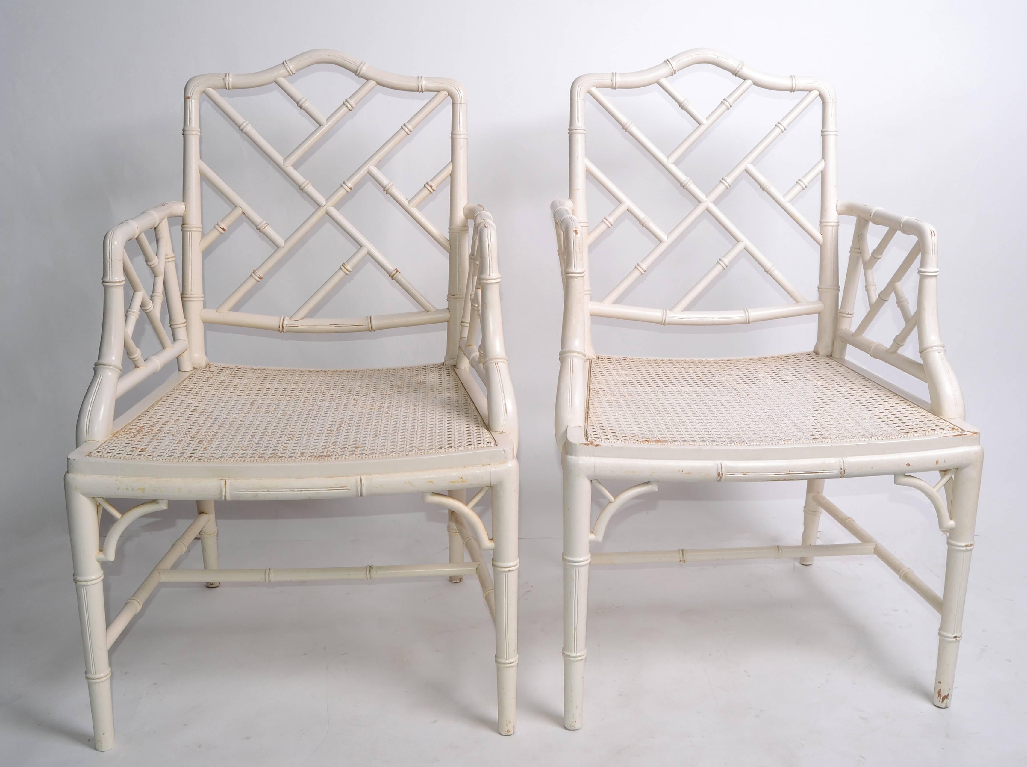 A pair of Hollywood Regency faux bamboo Chippendale armchairs.
Distressed paint.
No makers mark.

Seat height: 16 inches
Arm height: 26.63 inches.