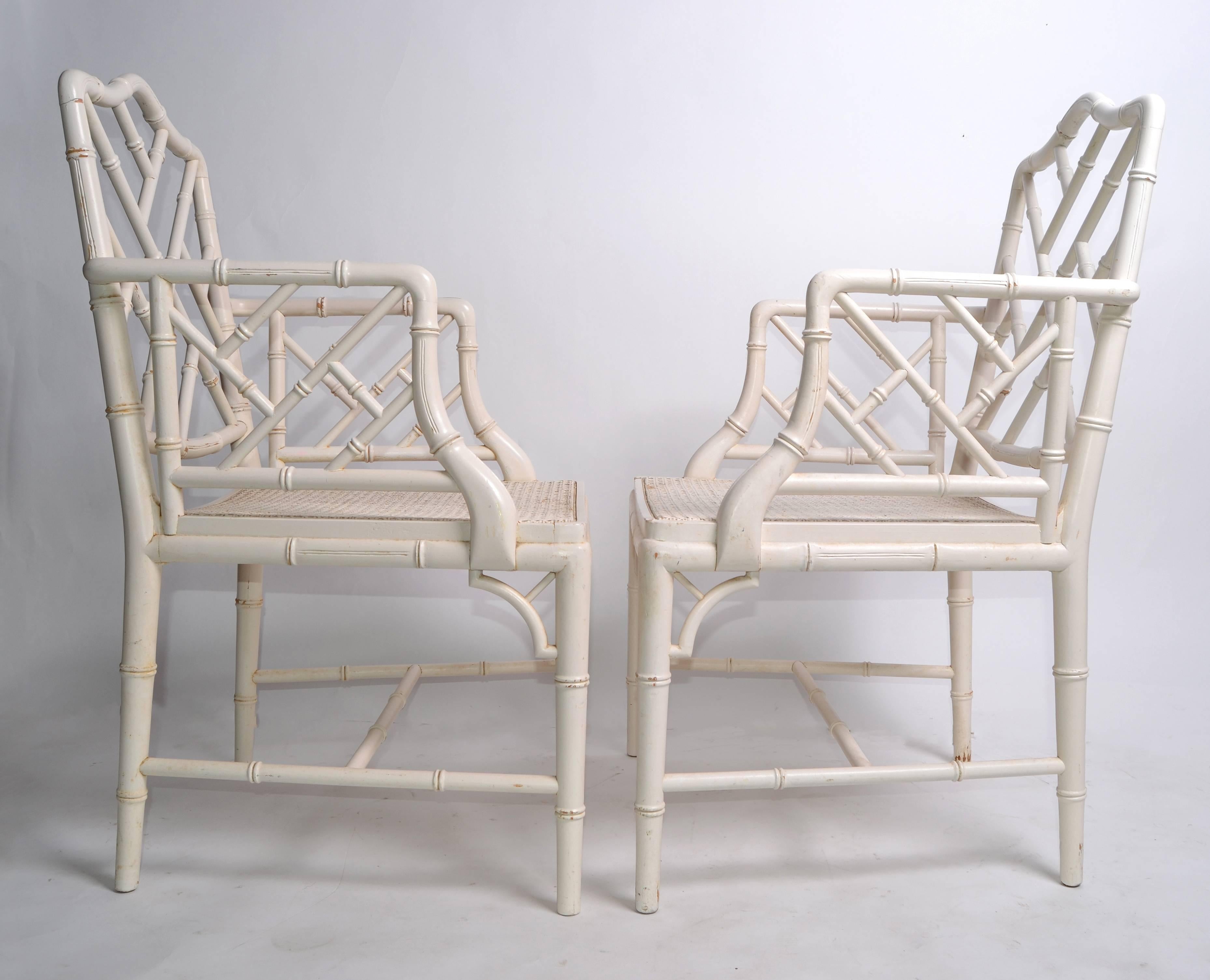 A pair of Hollywood Regency faux bamboo Chinese Chippendale armchairs.
Professionally refinished.
No makers mark.
Measures: Arm height 26.63 inches.