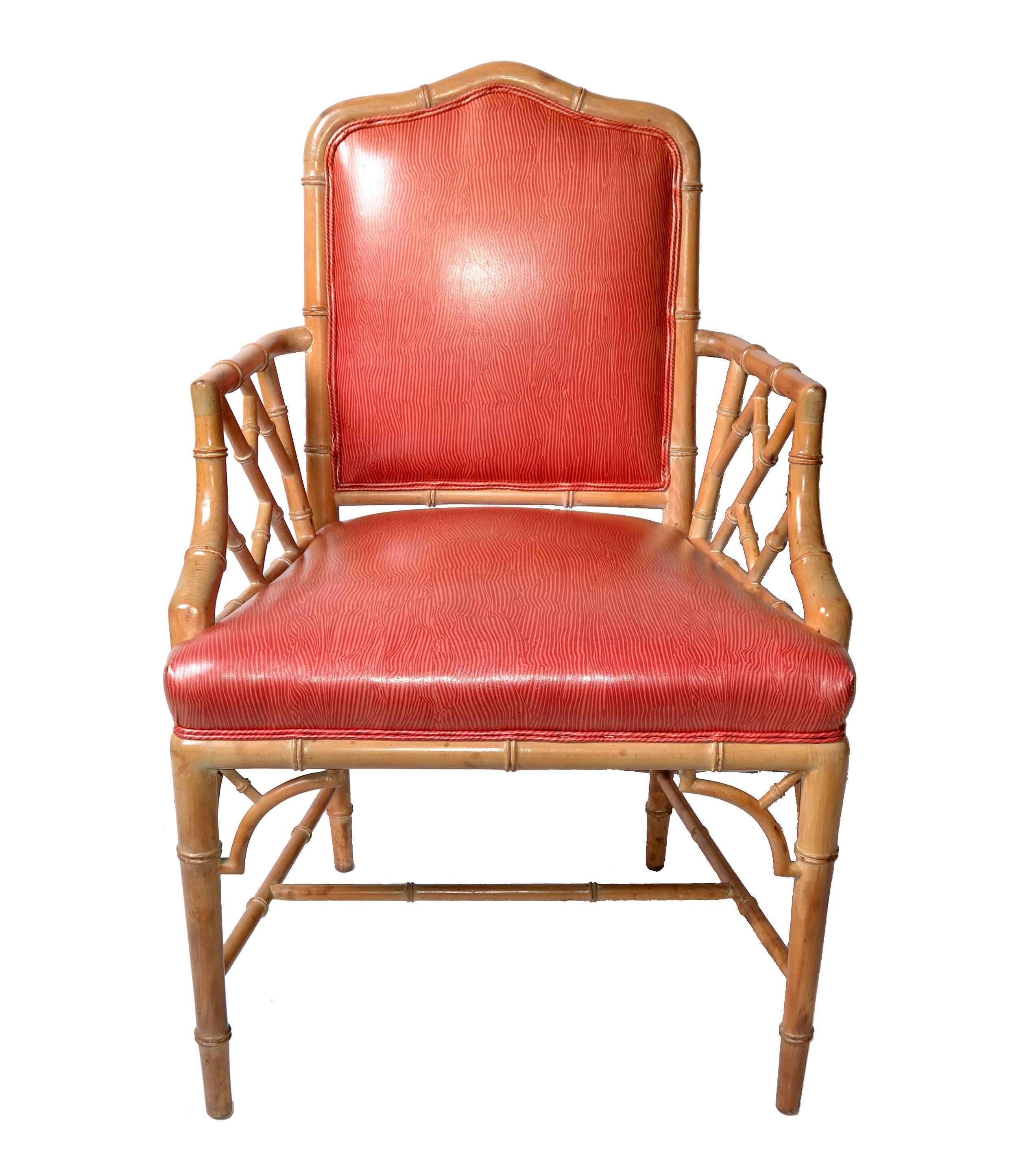 Set of eight faux bamboo Chinese Chippendale chairs in vinyl upholstery. There are six side chairs and two armchairs 
The chairs are firm, sturdy and very comfortable as the seats and backs are padded.
They are from the late 1950s and in good