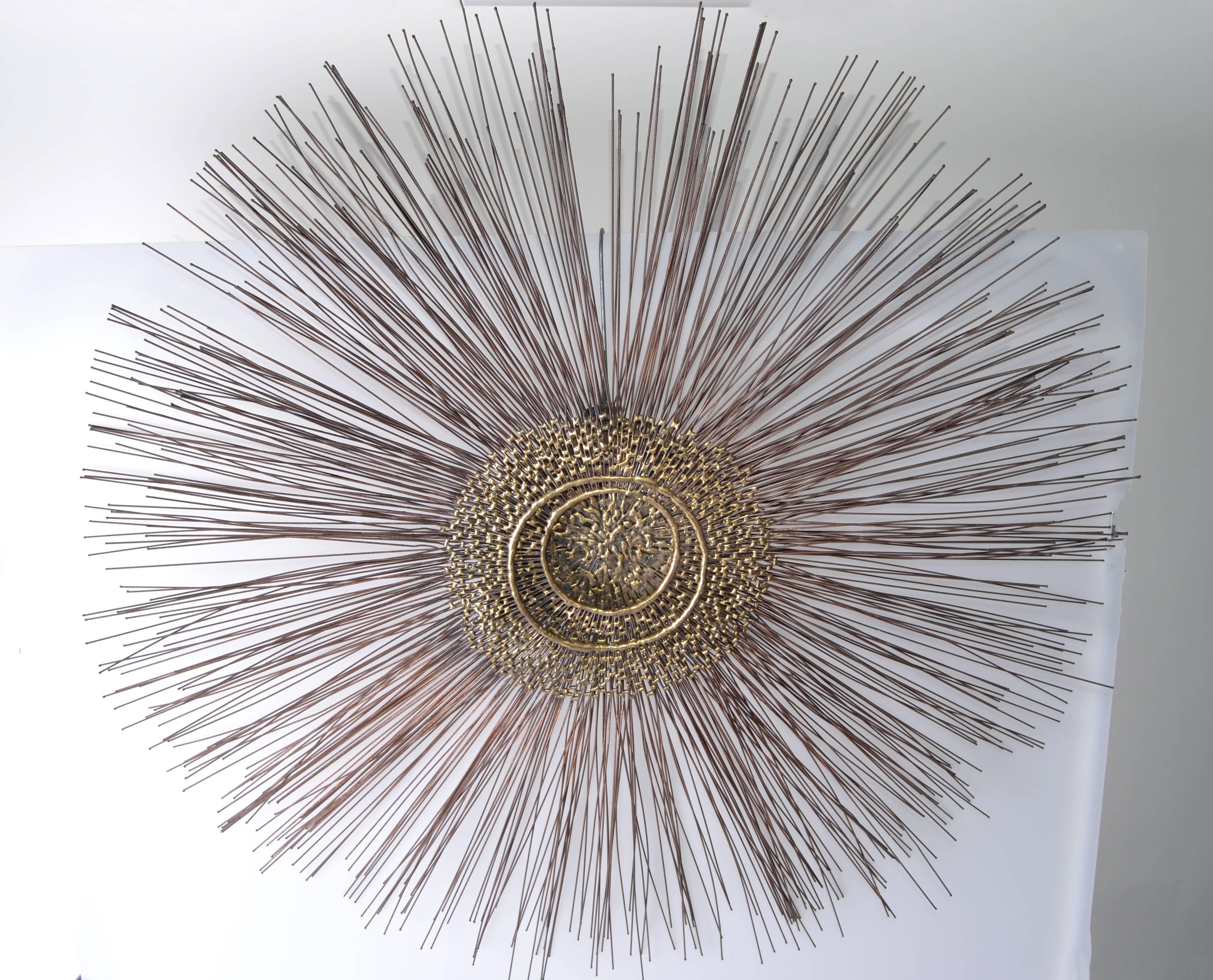 Striking 1960 soldered brass sunburst sculpture in the Style of Curtis Jere. Wonderful Mid-Century Modern three-layer sunburst metal sculpture with molten center. Hues of brass copper and black are all visible through the layers condition. No