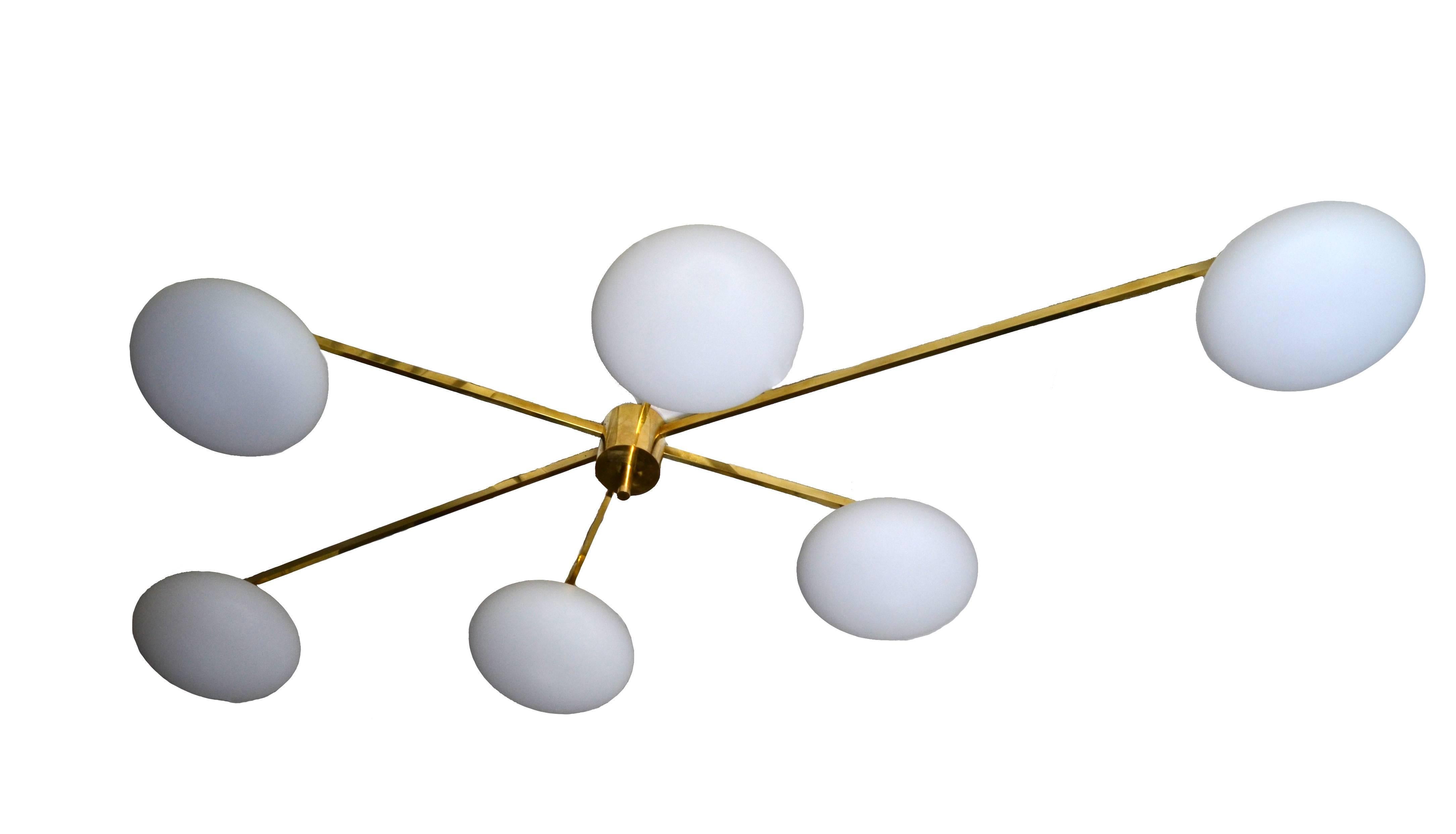 Modern cool Italian asymmetric brass chandelier with six opaline glass globes.

Uses six round max. 40 wattage light bulbs.