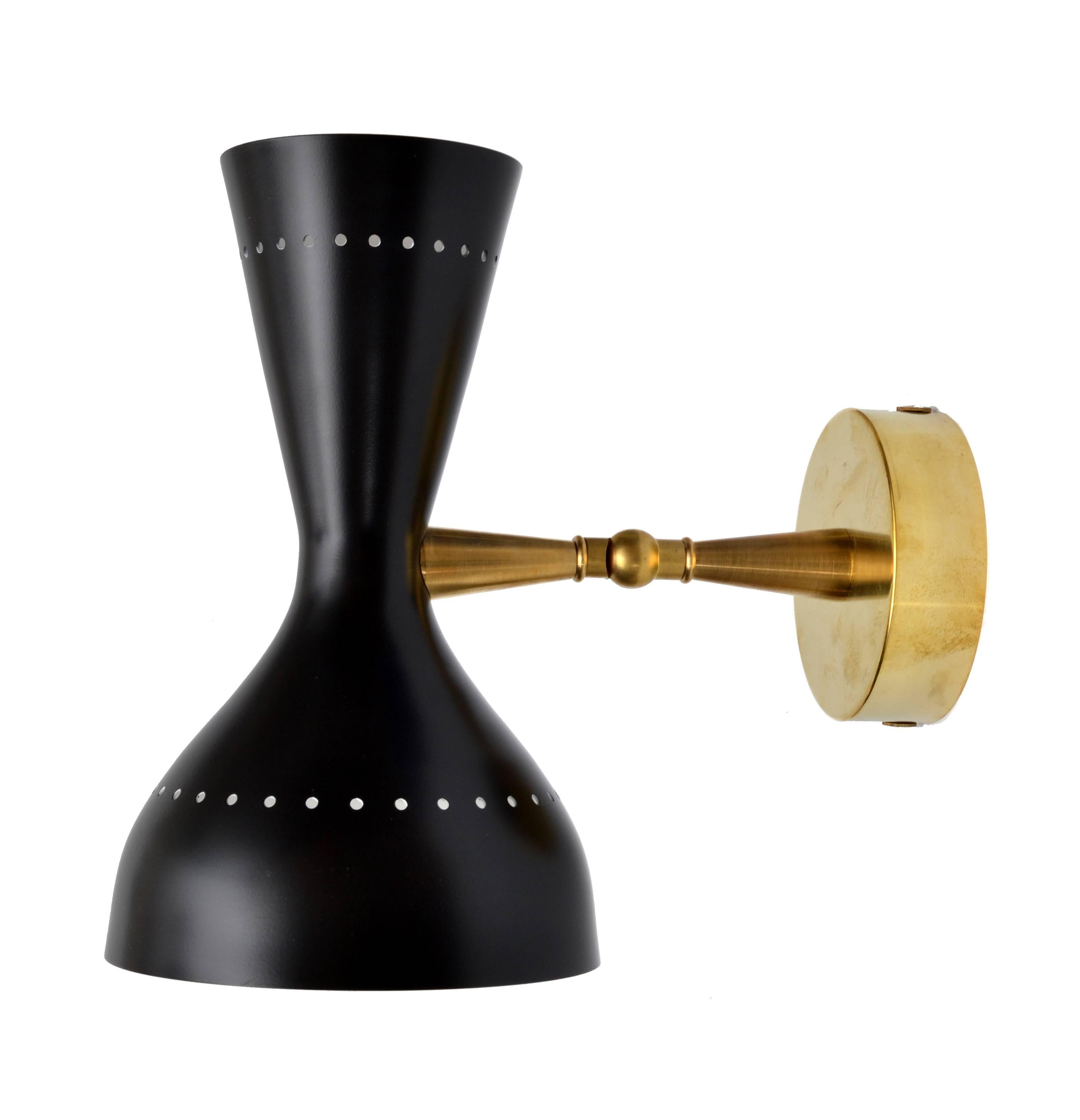 Stunning Italian diabolo style sconce in brass with black metal shade.
Dual lamp shade houses one small (E14-40W) bulb and a larger shade for a (E27-60W) standard bulb.
The arm and head are adjustable.