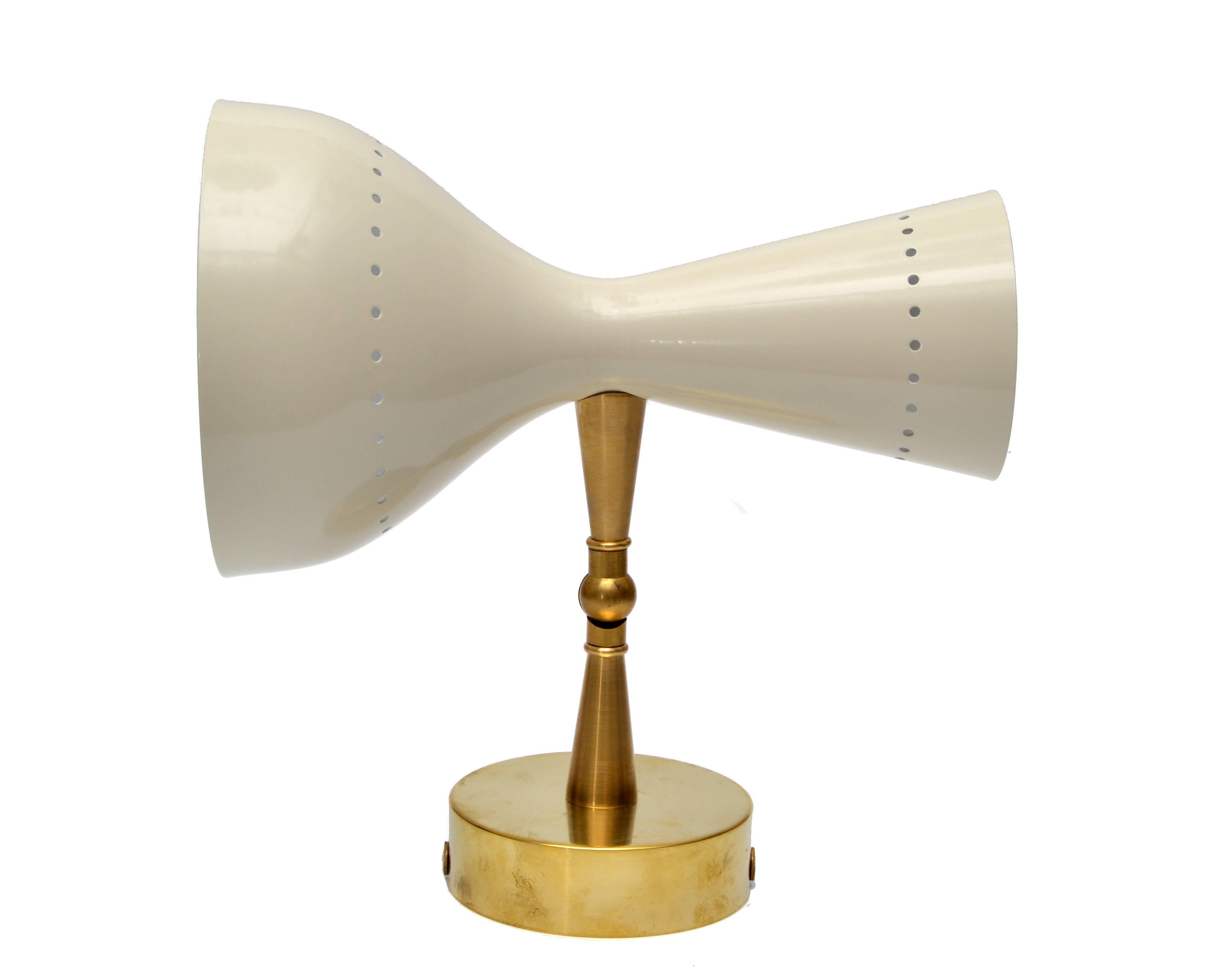 Stunning Italian Diabolo style sconce in brass with Beige and white metal shades.
Dual lampshade houses one small (E14-40W) bulb and a larger shade for a (E27-60W) standard bulb.
The arm and head are adjustable.
Some patina to the Brass.
 