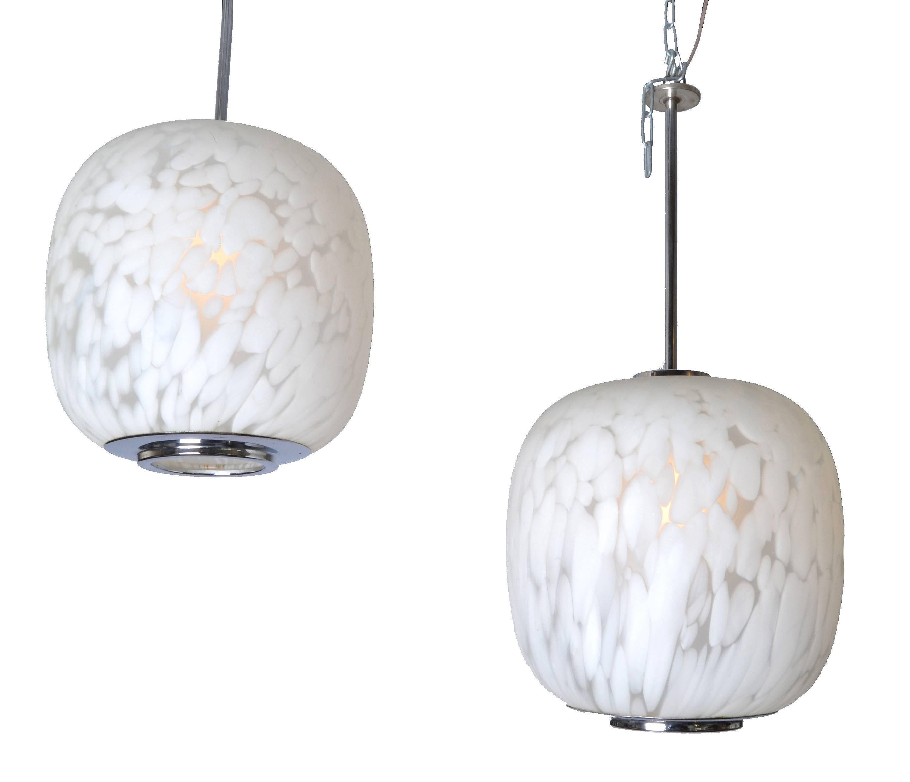 A pair of Italian pendant light attributed to Mazzega. Manufactured, circa 1960 in mottled white Murano glass with chrome shaft and base.
Wired for the U.S. and uses a 60 watts light bulb.
All original vintage condition.