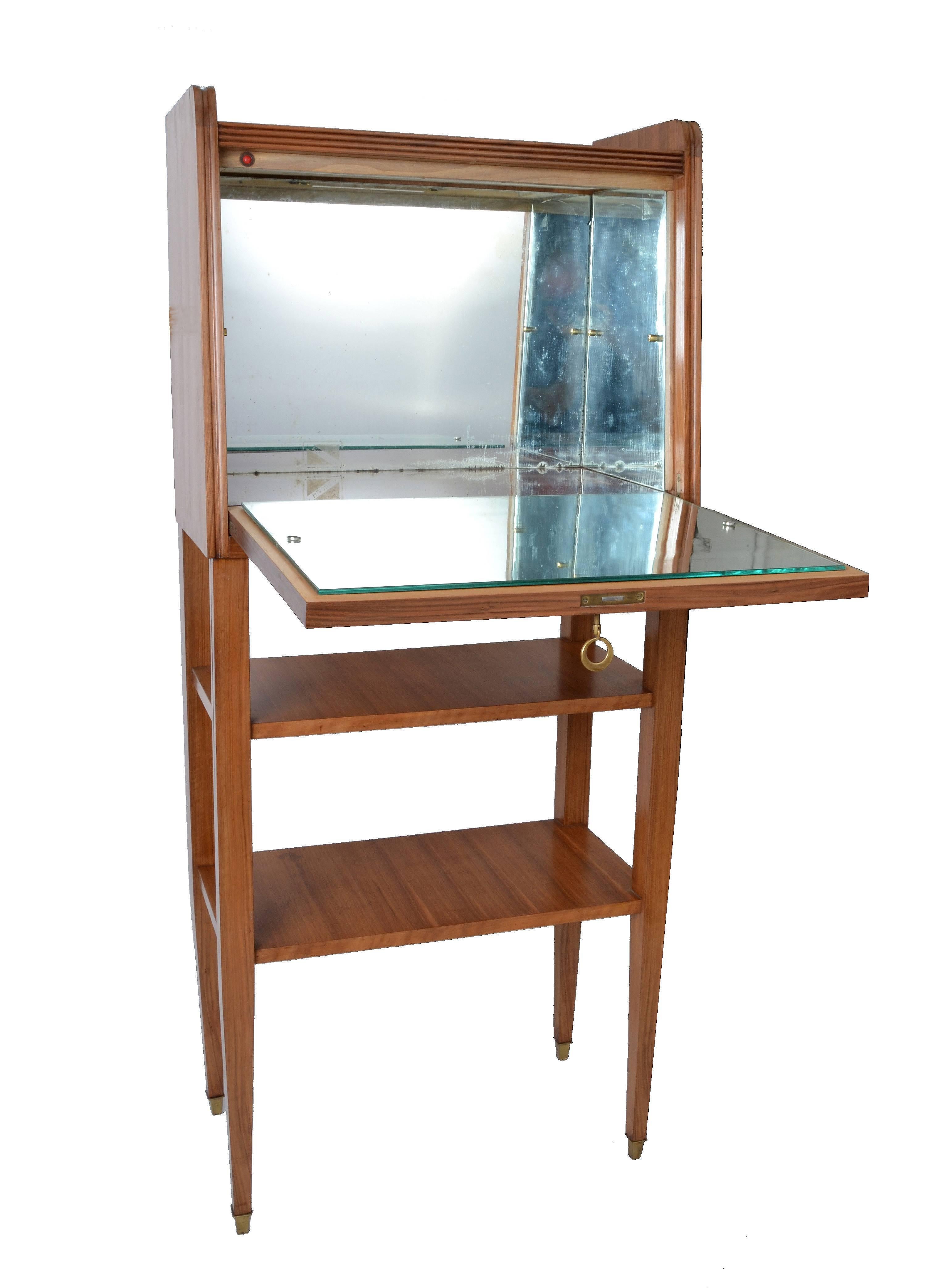 Art Deco Style tall wooden Dry Bar or High Bar made in Italy with carved instruments Marquetry on the drop-down door.
Two shelves for storage of Glassware Sets, Drinkware, Tumblers and Culver Glass.
The inside is featured with mirror glass and has a