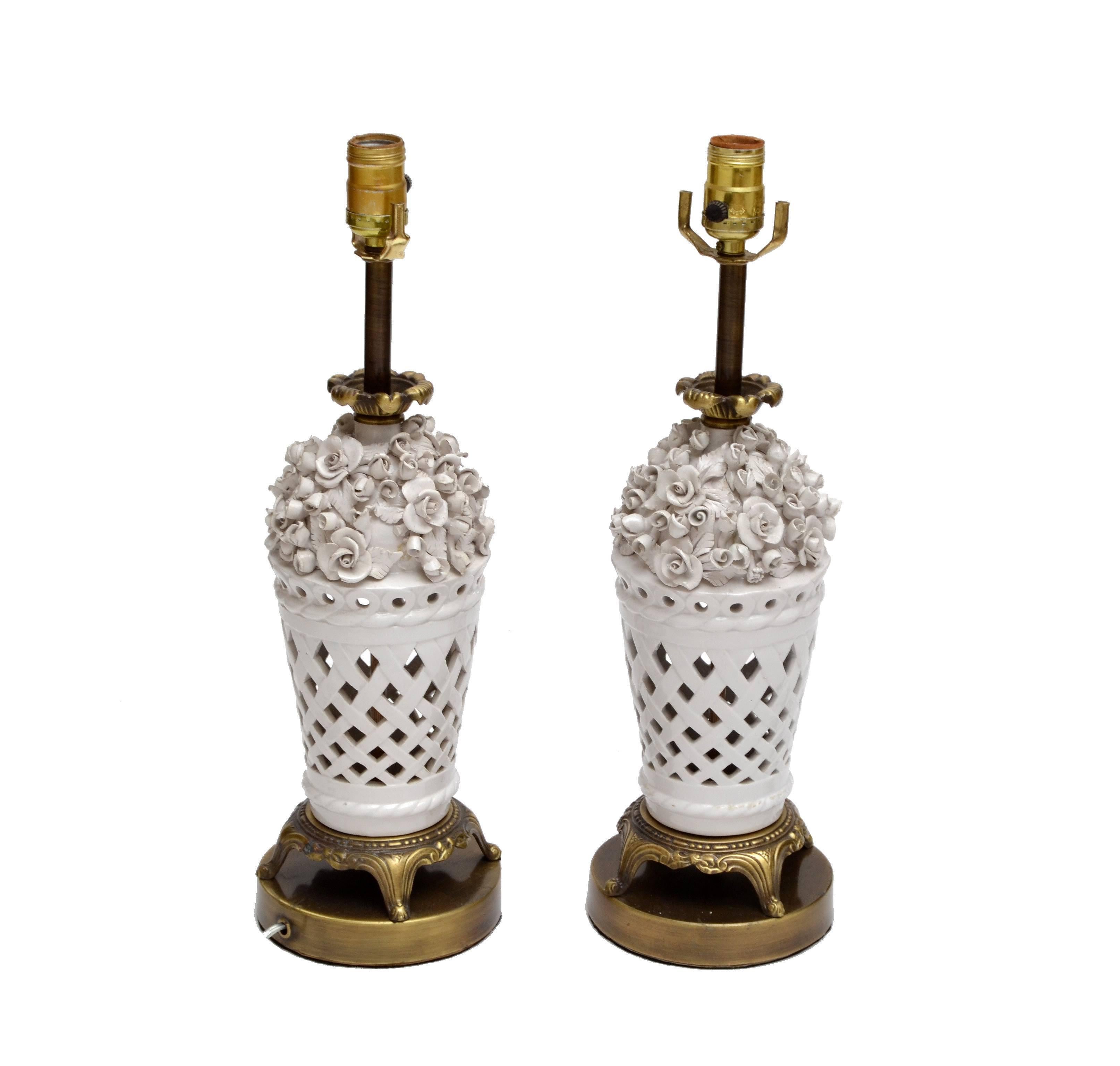 A pair of white porcelain table lamps in capodimonte style with bronze feet and ruffle.
In perfect working condition and each uses a max. 60 watts light bulb.
 