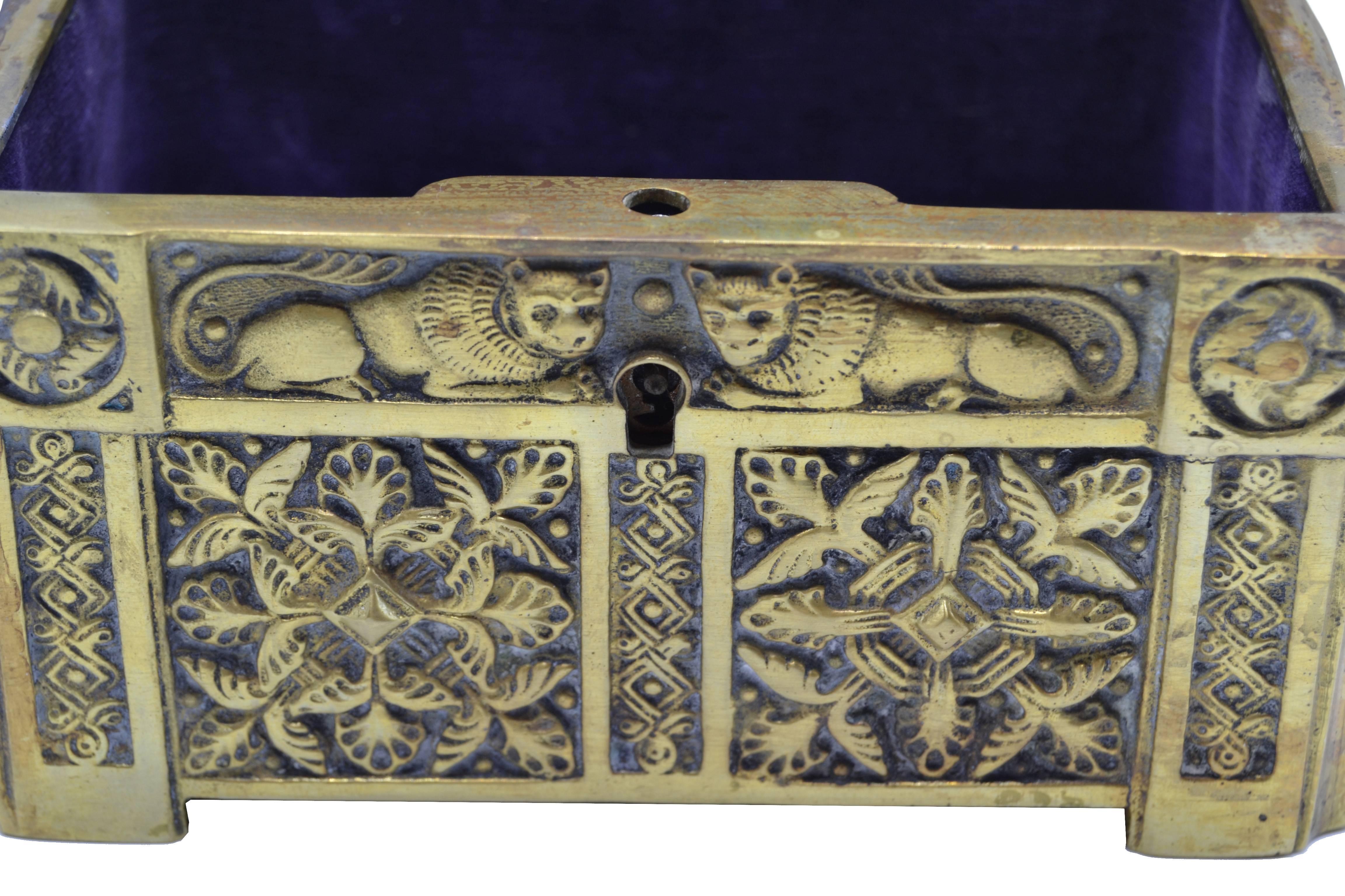 a small bronze box with engravings carried at the waist