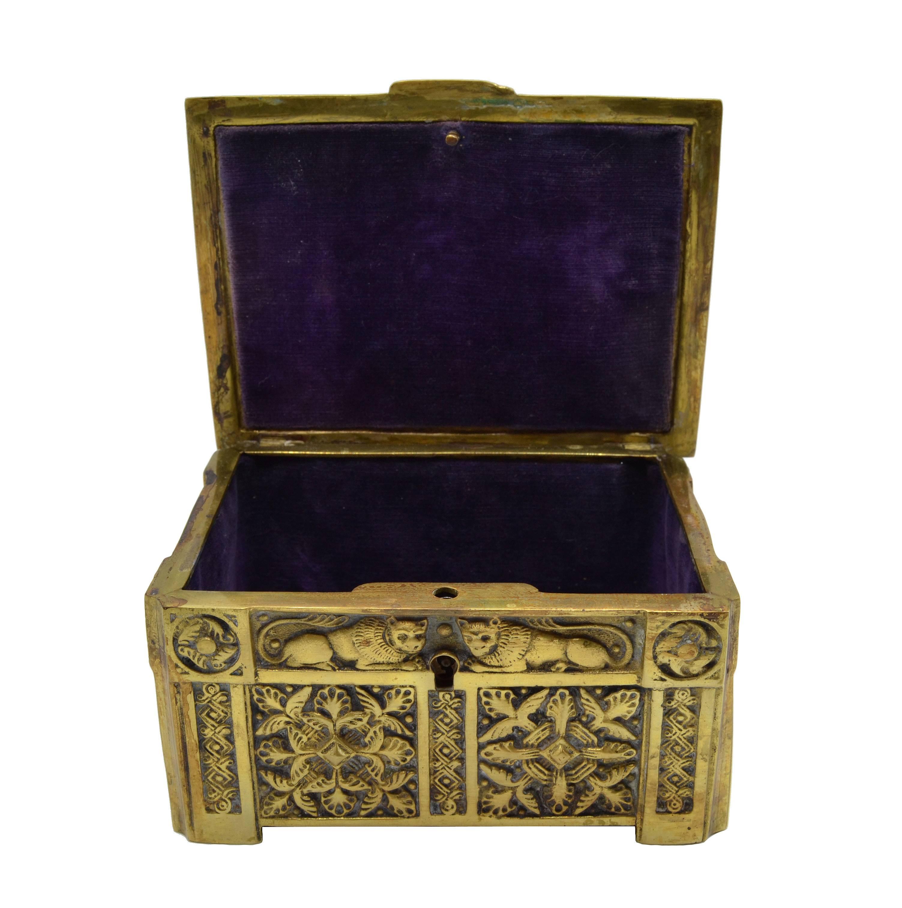 a small bronze box with engravings carried at the waist