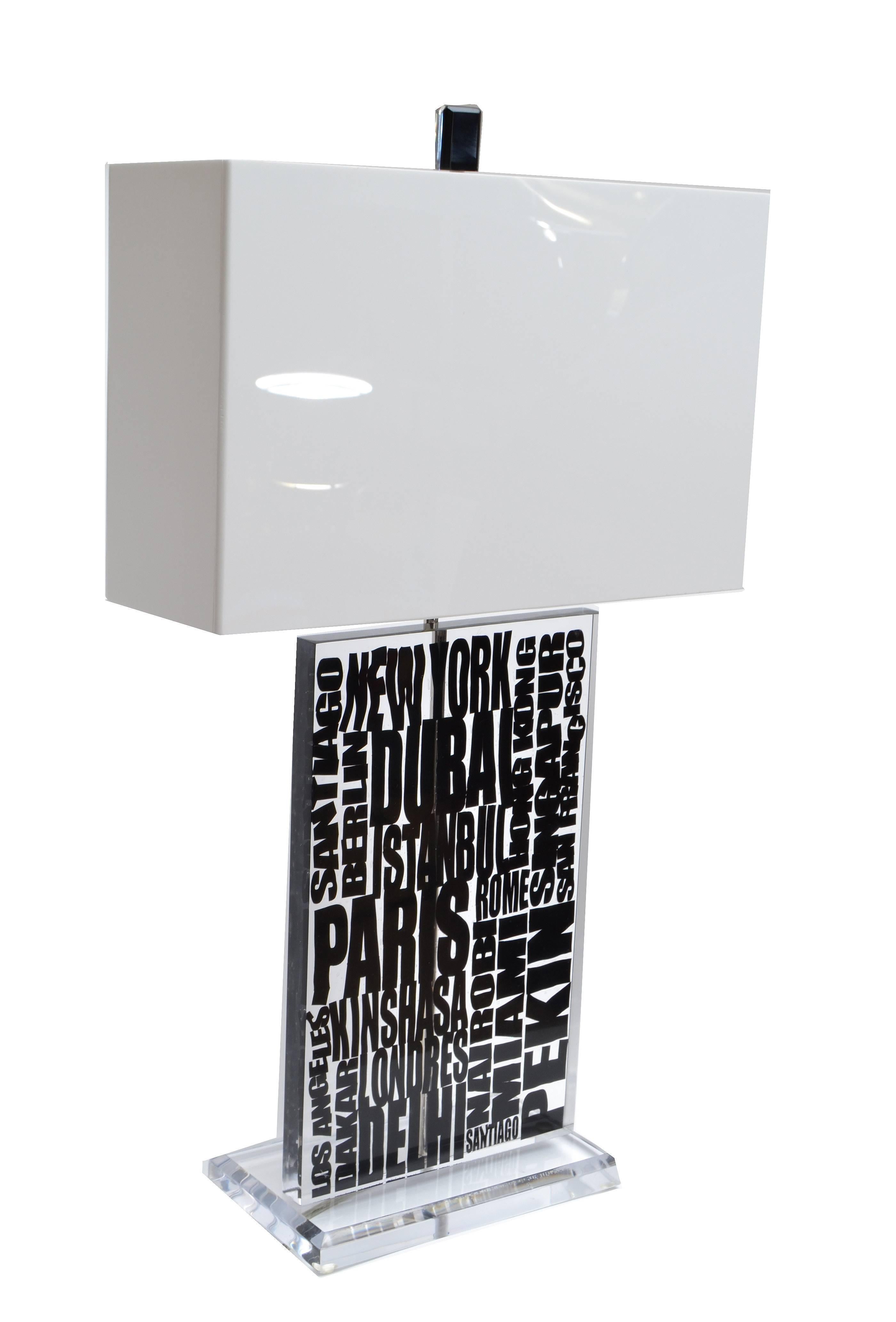 Super cool modern Op Art Lucite table lamp with white acrylic shade.
The core is transparent with famous international cities written out.
Wired for the U.S. and uses a max. 60 wattage light bulb.
Dimension shade:
Length: 16.0 inches, Depth: 5.5