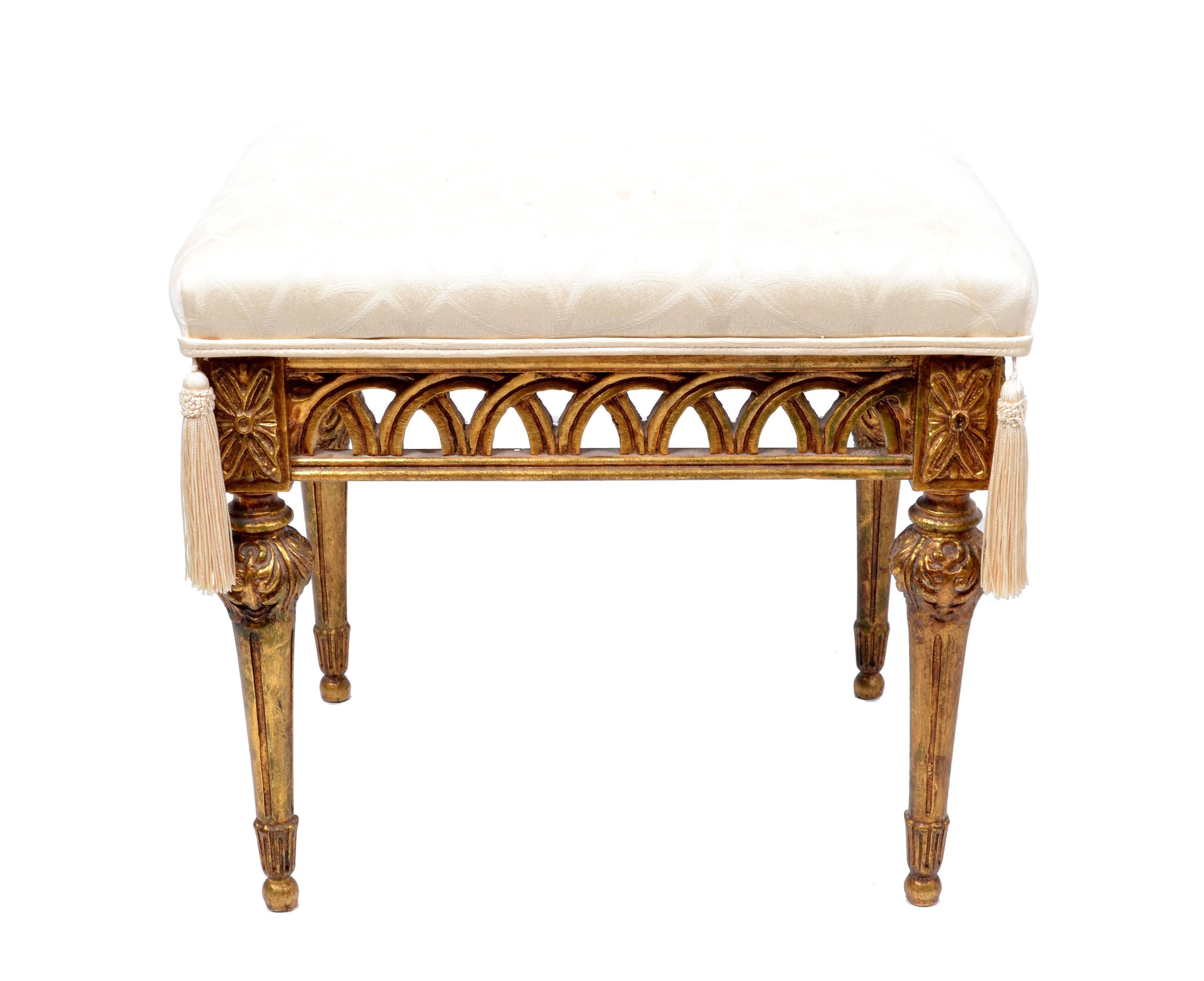 A pair of Italian stools in giltwood finish.
The original cream colored fabric is decorated with two tassels at the front.
This pair fits to any design and makes a great impression.