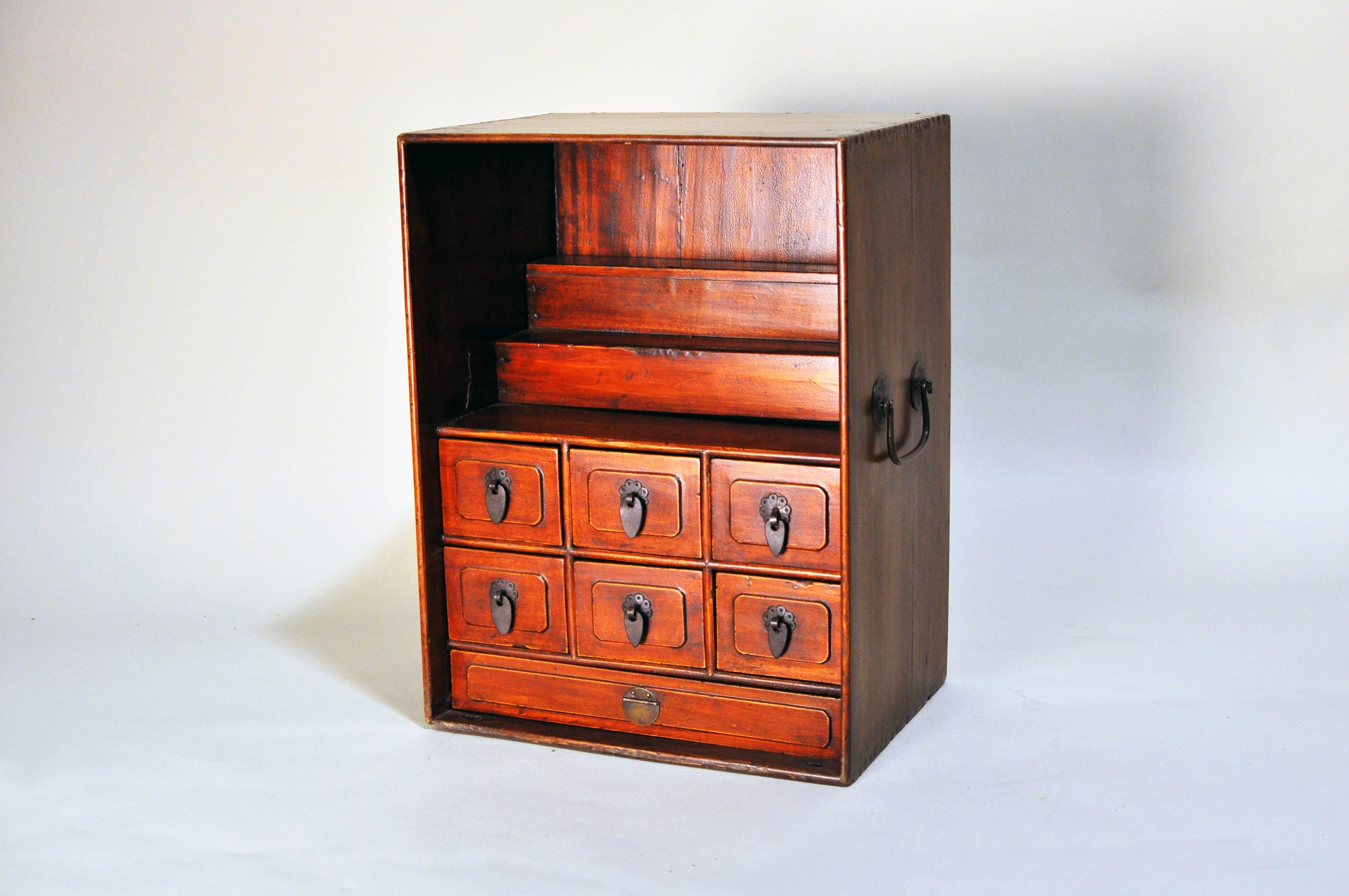 This petite box features a stepped display raised above six smaller drawers, which would have held writing implements such as pens, brushes, inks, wax and seal presses, while the larger fitted drawer at the base was used to store paper.