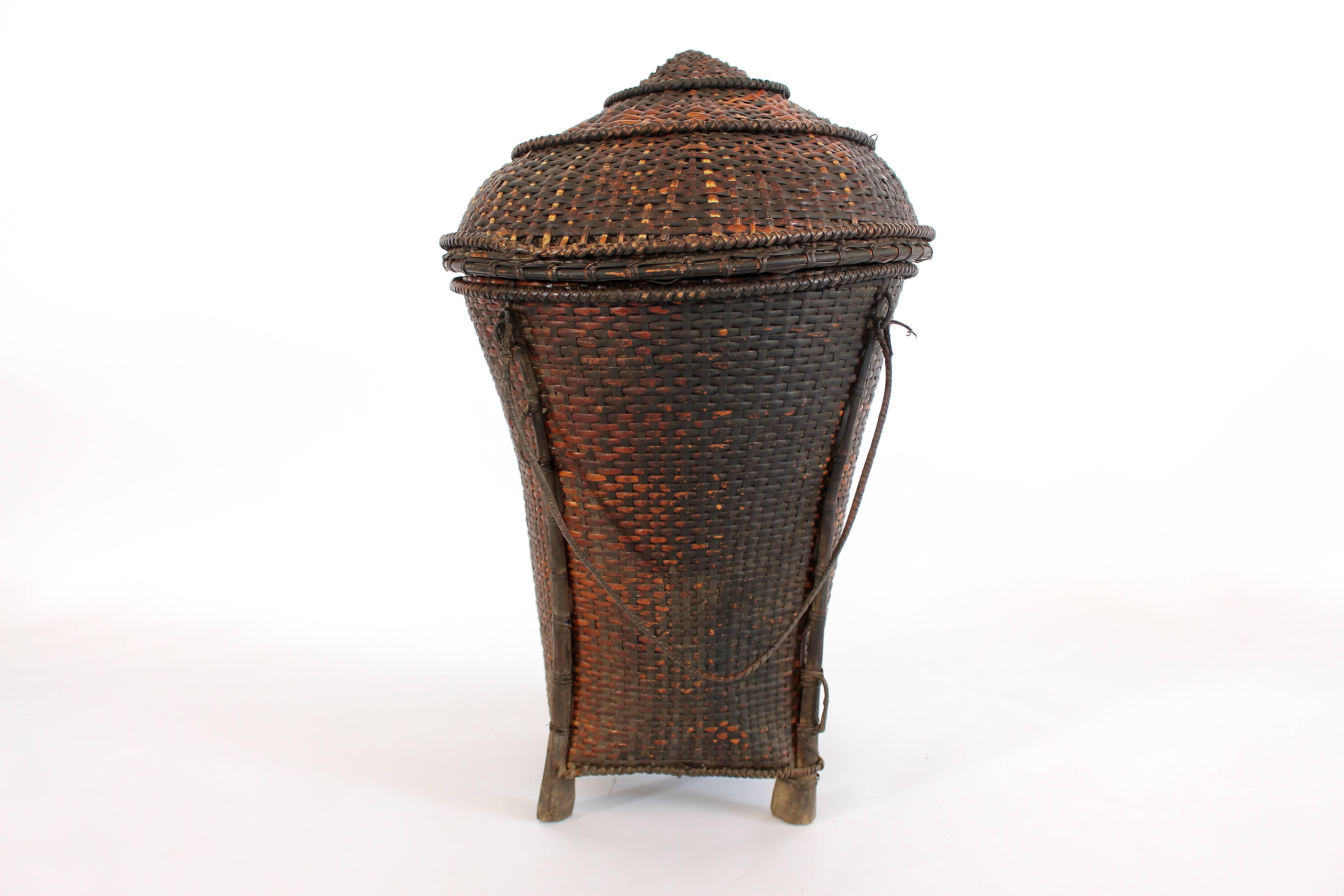 Baskets were used for the transportation and storage of foodstuffs. Baskets like this, with lids and short feet were kept indoors to store rice and keep it dry.

Still one of the world’s most isolated societies, the Naga were once enthusiastic