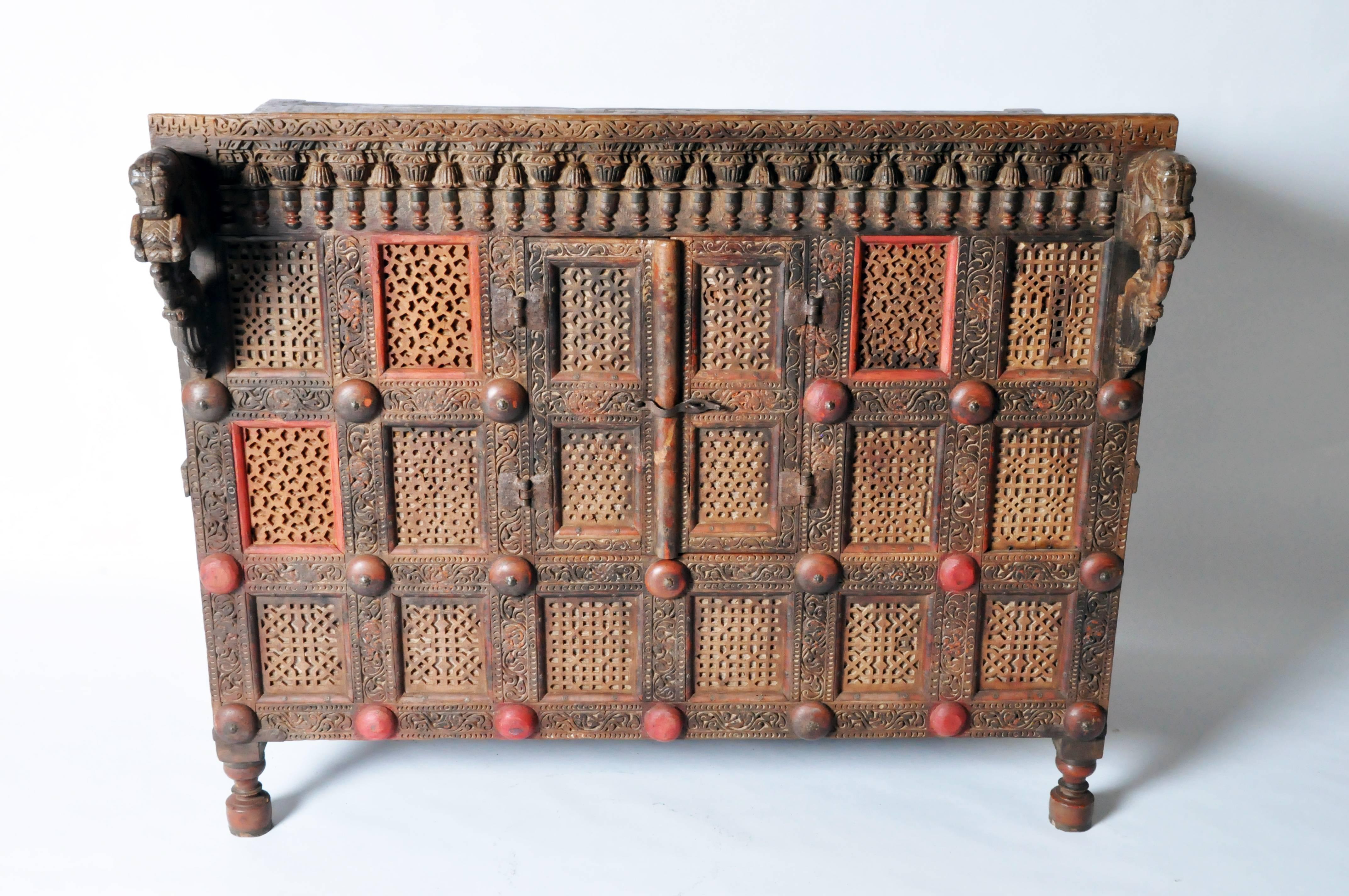 Traditionally used to store bridal dowries, this impressive wedding chest makes for an excellent sideboard or console. Intricately hand-carved with geometric patterns throughout, it features relief carved panels, two leaping horse-form brackets and